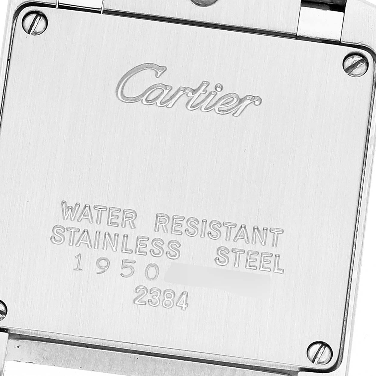 The image shows the back case of a Tank Francaise model by Cartier, displaying the brand, water resistance, material, and some serial numbers.