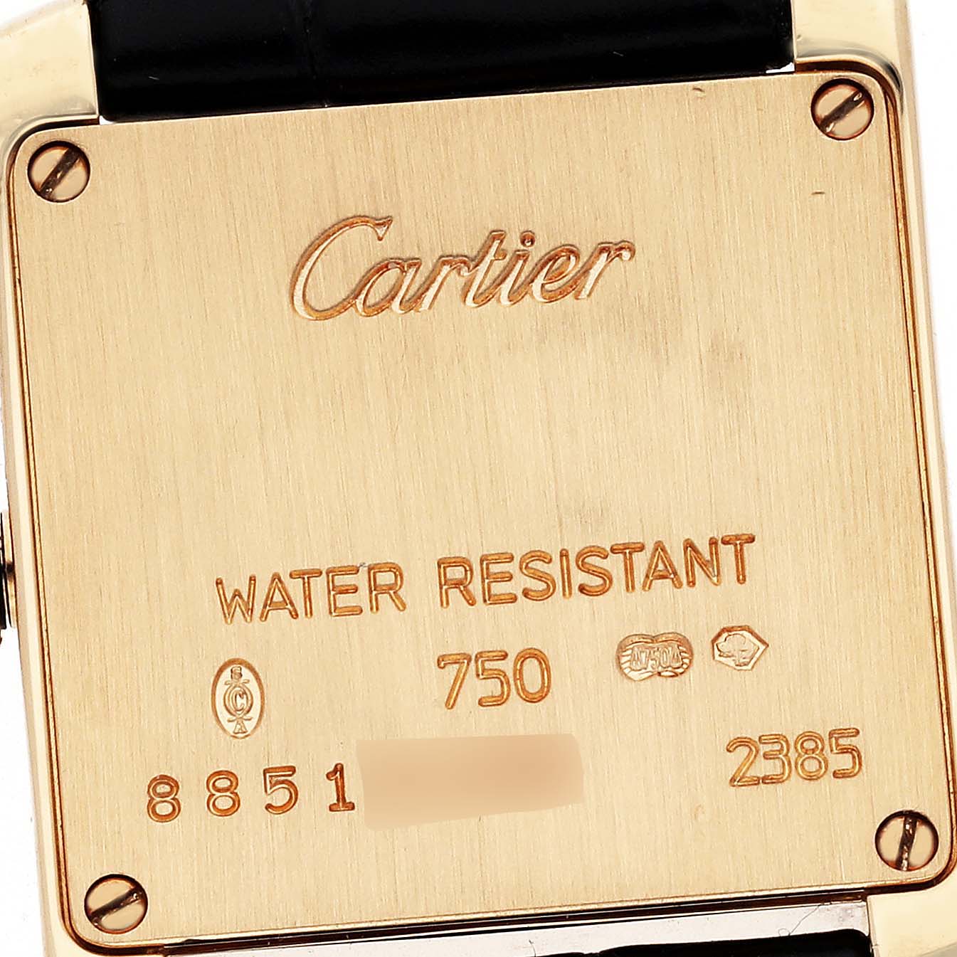 The image shows the back case of a Cartier Tank Française watch with brand engravings.