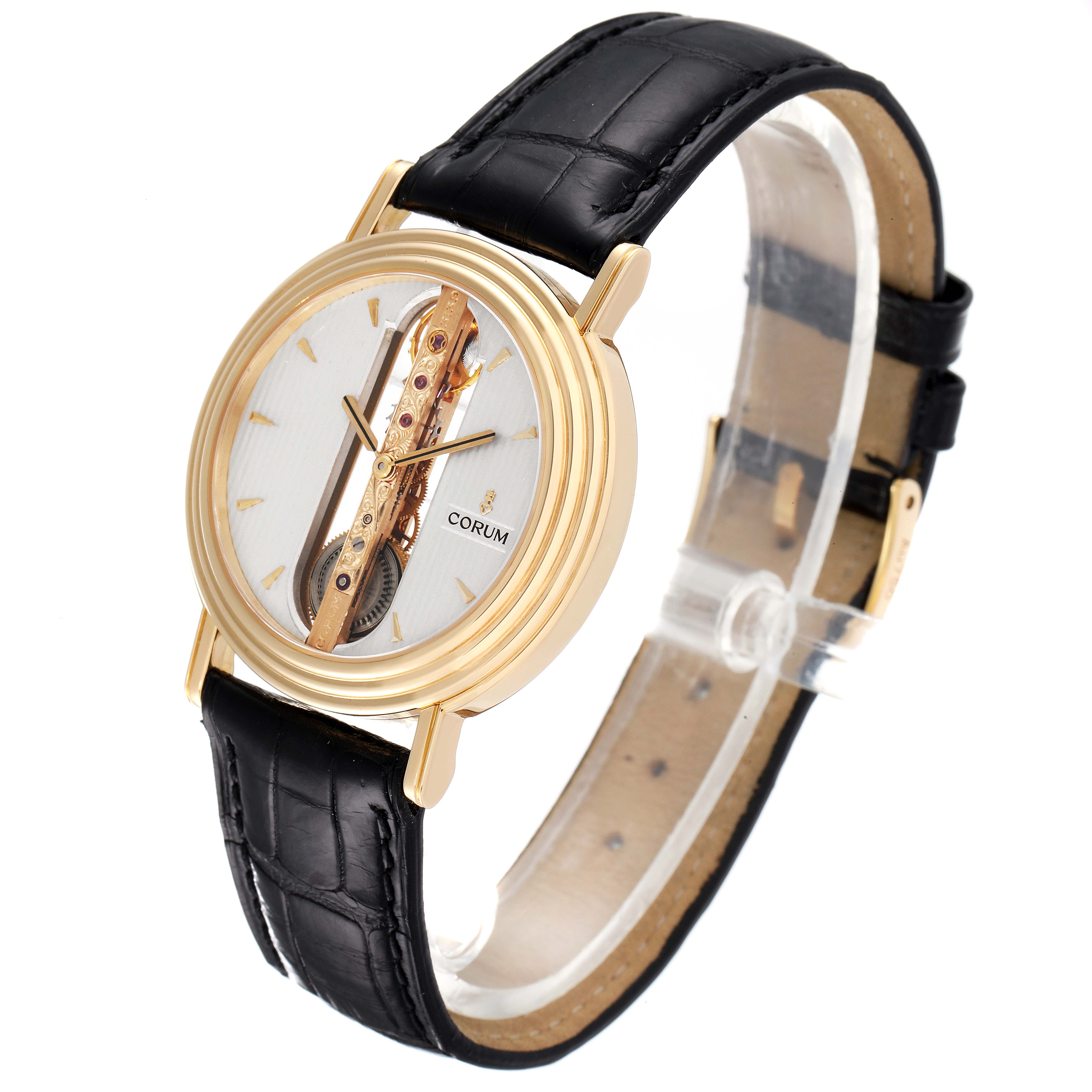 The image shows a Corum Golden Bridge 13.240.58 Men's Yellow Gold Silver Dial 13.240.58 Men's Yellow Gold Silver Dial watch at a 3/4 angle, highlighting its intricate dial and black leather strap.