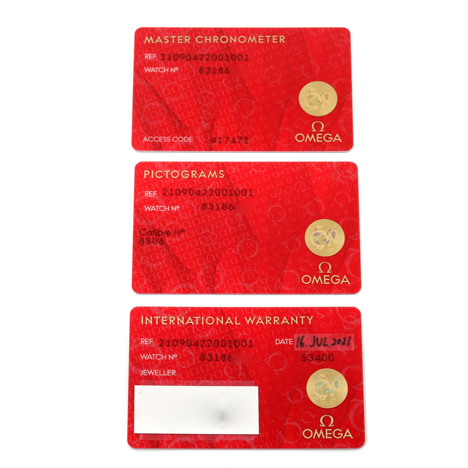 The image shows three red cards from Omega for the Seamaster model: Master Chronometer, Pictograms, and International Warranty.