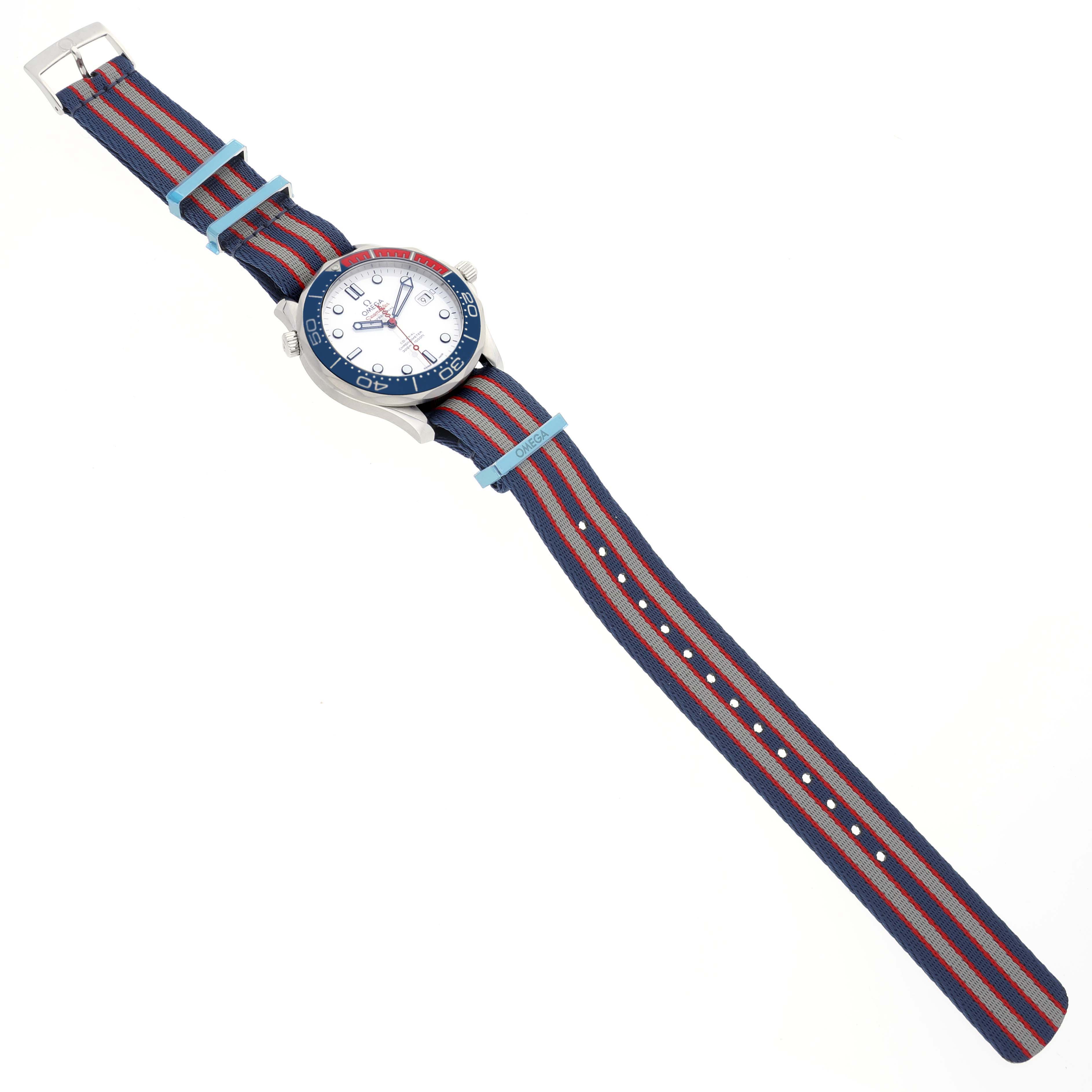 The Omega Seamaster 212.32.41.20.04.001 Men's Stainless Steel White Dial 212.32.41.20.04.001 Men's Stainless Steel White Dial watch is shown from an overhead angle, displaying its face and colorful striped fabric strap in full length.