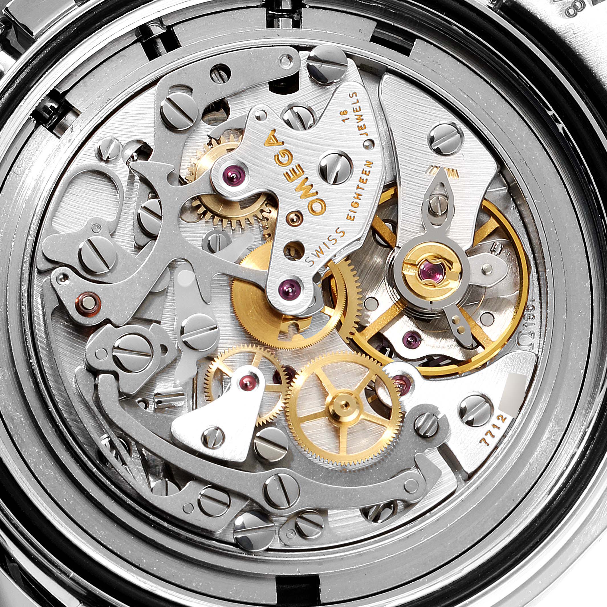 The image shows a close-up of the Omega Speedmaster 3570.50.00 Men
s Stainless Steel Black Dial 3570.50.00 Men
s Stainless Steel Black Dial watch’s intricate movement mechanism.