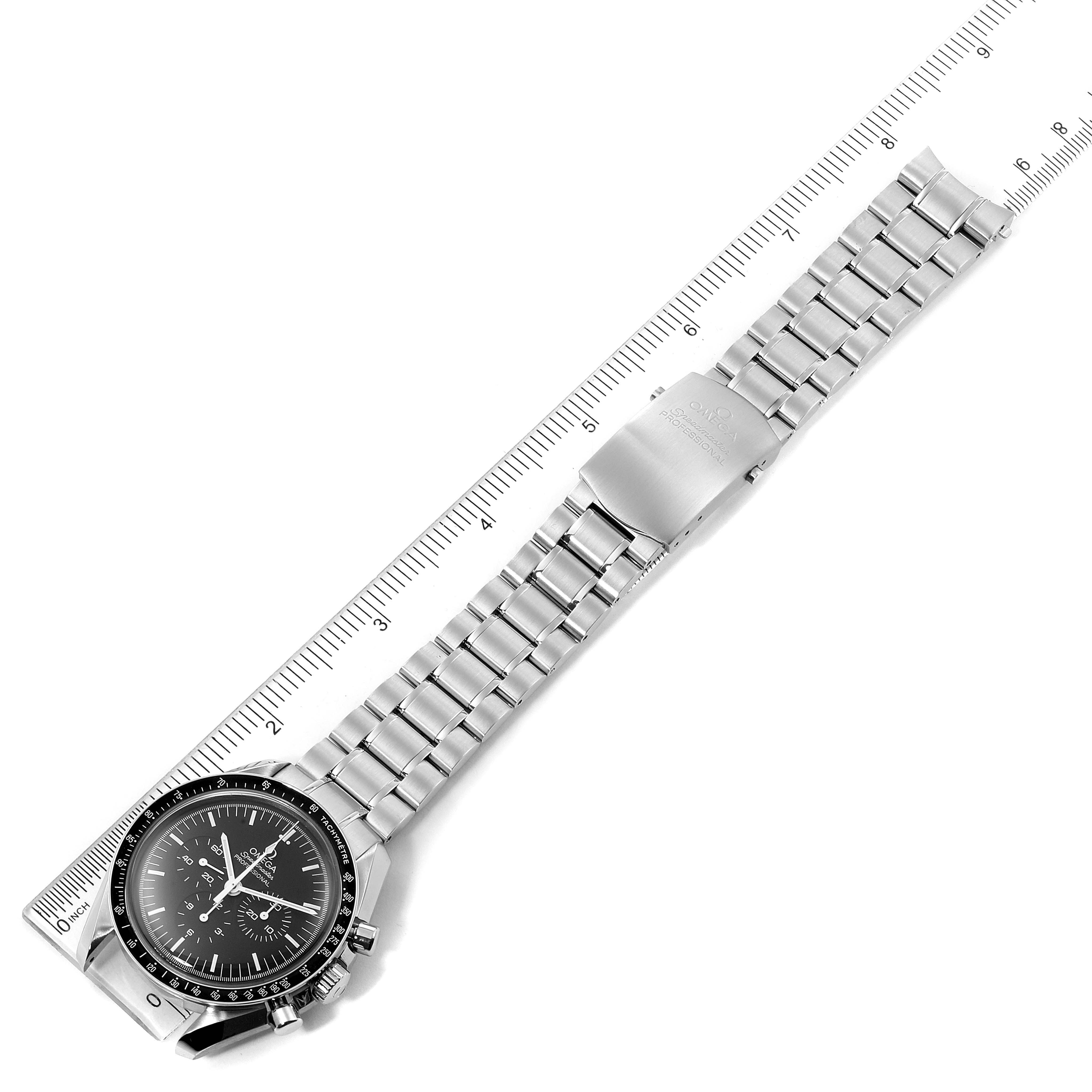 The image shows an overhead view of an Omega Speedmaster 311.30.42.30.01.005 Men
s Stainless Steel Black Dial 311.30.42.30.01.005 Men
s Stainless Steel Black Dial watch, highlighting its face, bezel, and metal bracelet with a ruler for scale.