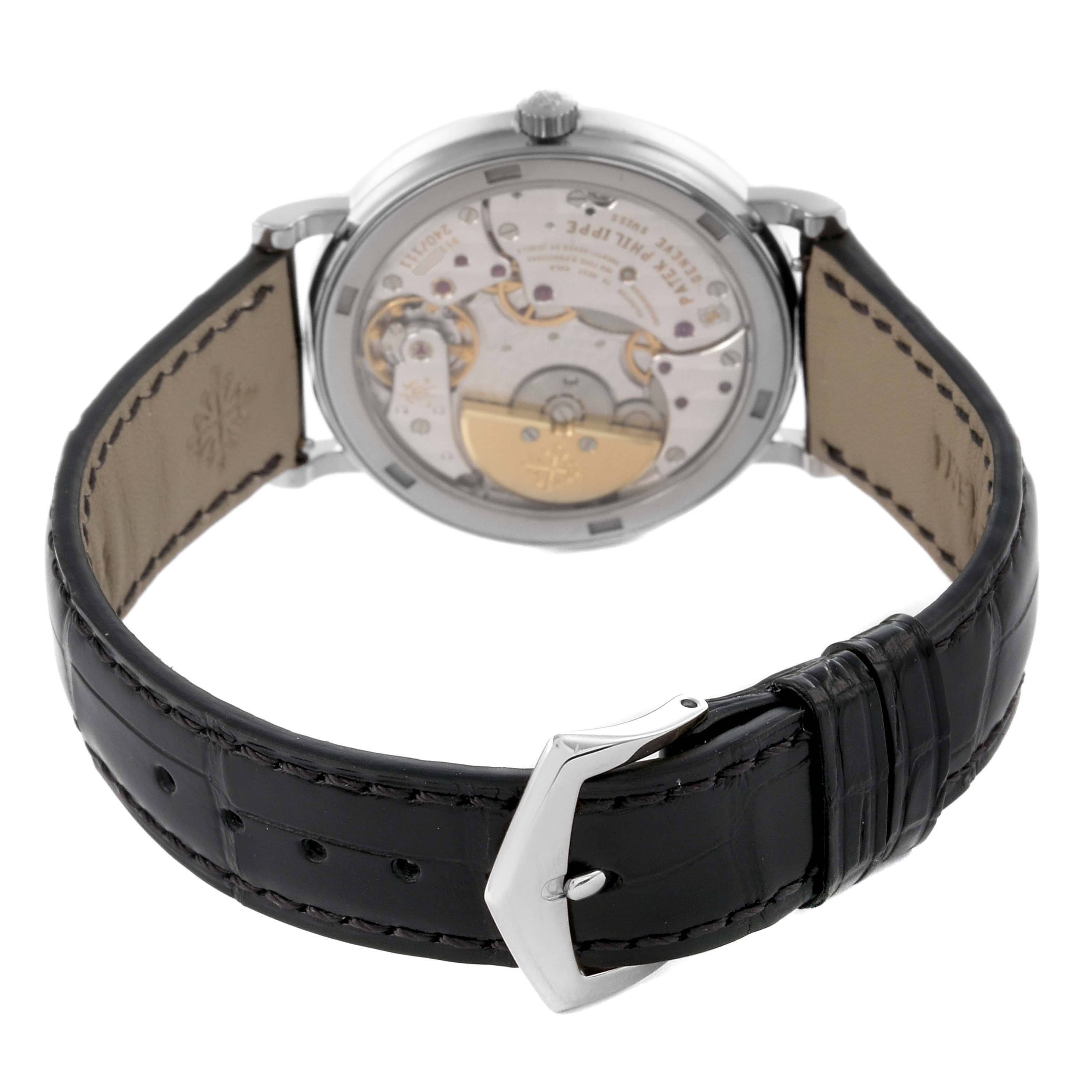 The Patek Philippe Calatrava 5120G Men's White Gold White Dial 5120G Men's White Gold White Dial watch is shown from a rear angle, displaying its movement and leather strap.