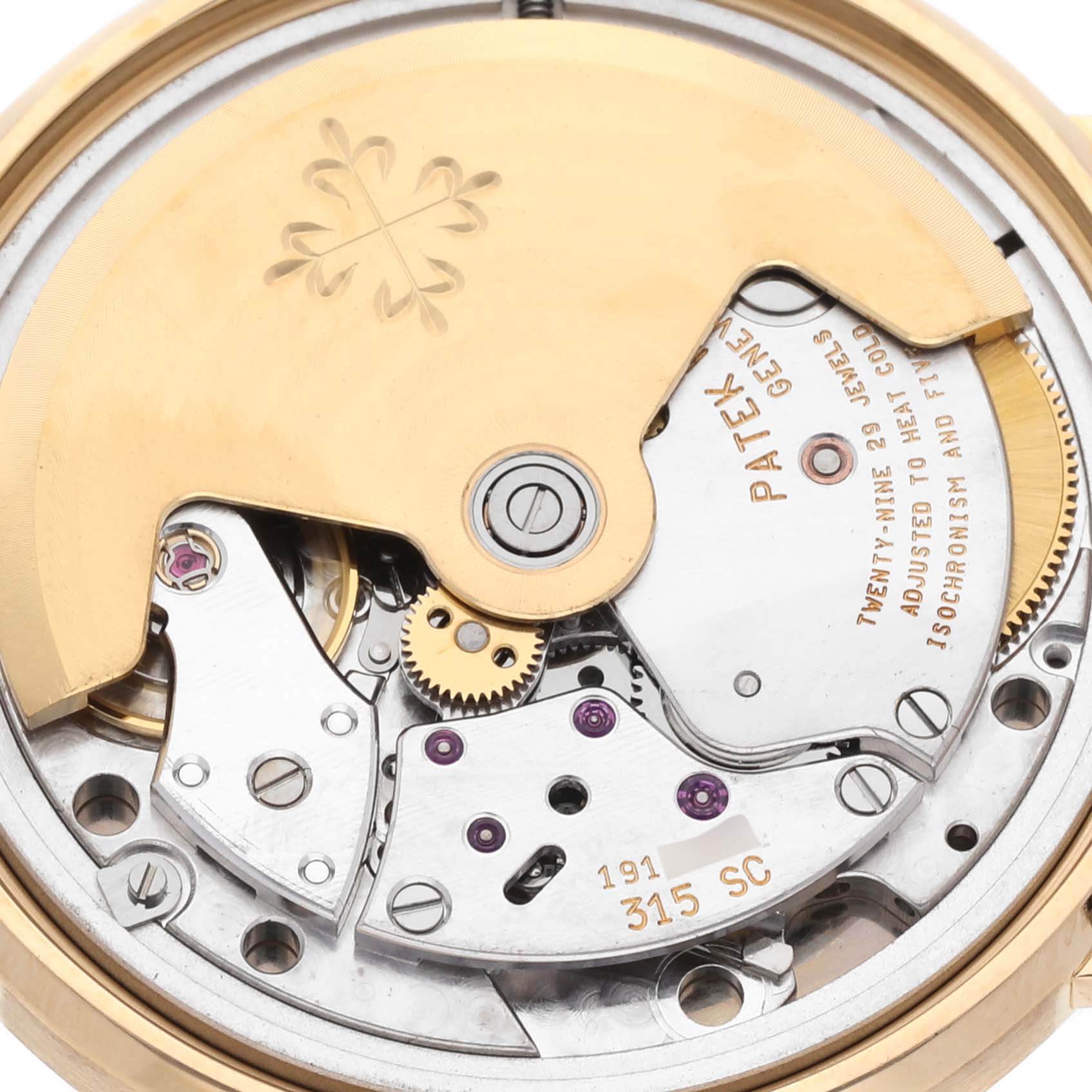 The image shows the Calatrava model by Patek Philippe from the back, highlighting its movement and intricate mechanism.
