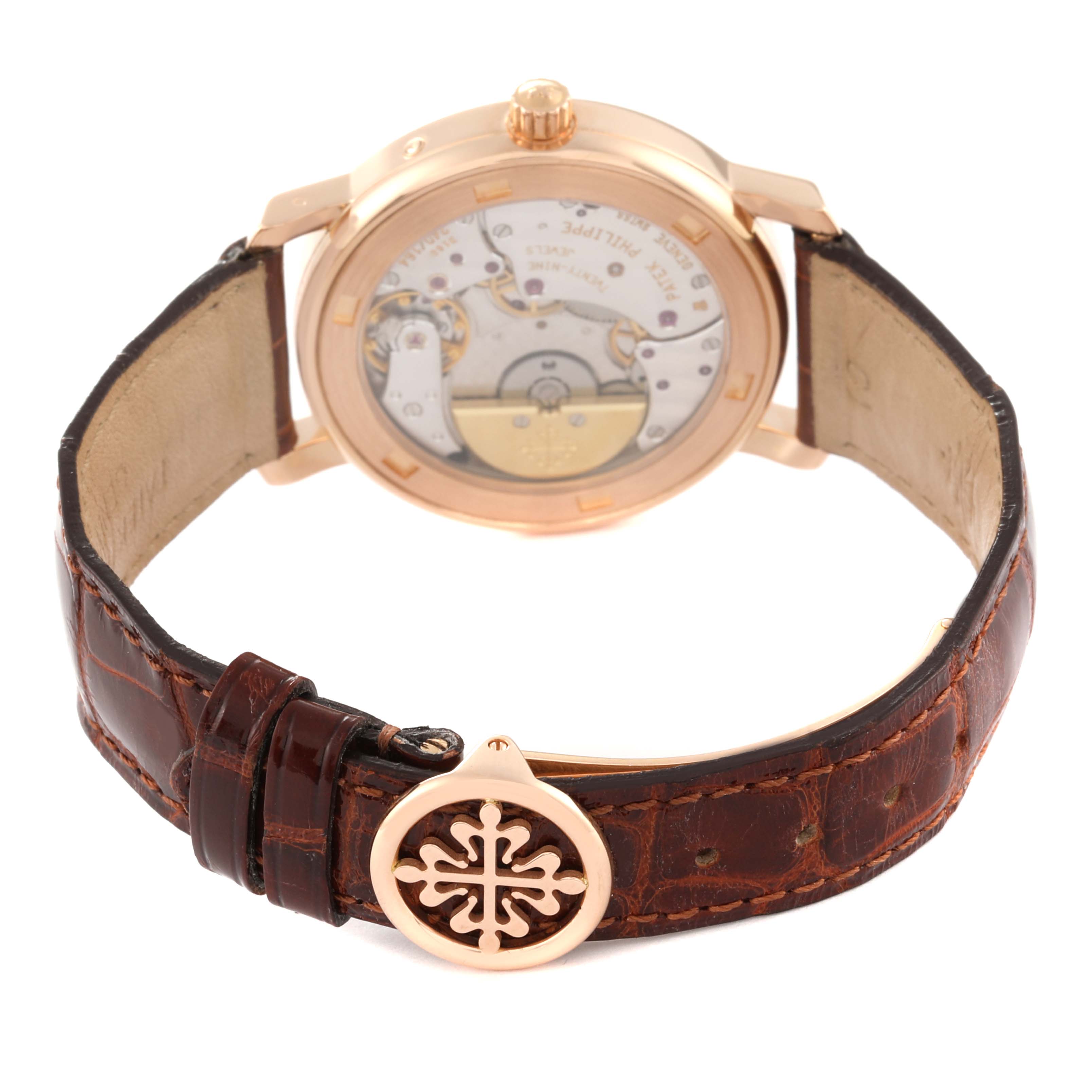This image shows the back view of a Patek Philippe Complications 5055R-001 Men's Rose Gold Champagne Dial 5055R-001 Men's Rose Gold Champagne Dial model watch, detailing its movement and leather strap.