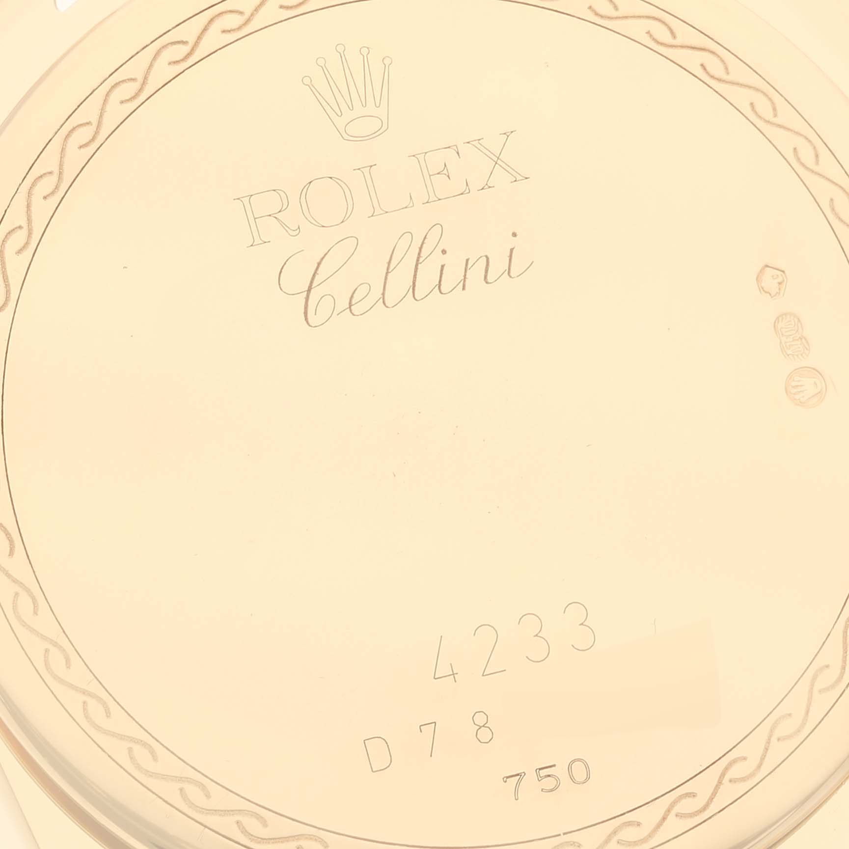 This is a close-up of the back case of a Rolex Cellini 4233/8 Men's Yellow Gold Black Dial 4233/8 Men's Yellow Gold Black Dial model, showing engravings and hallmarks.