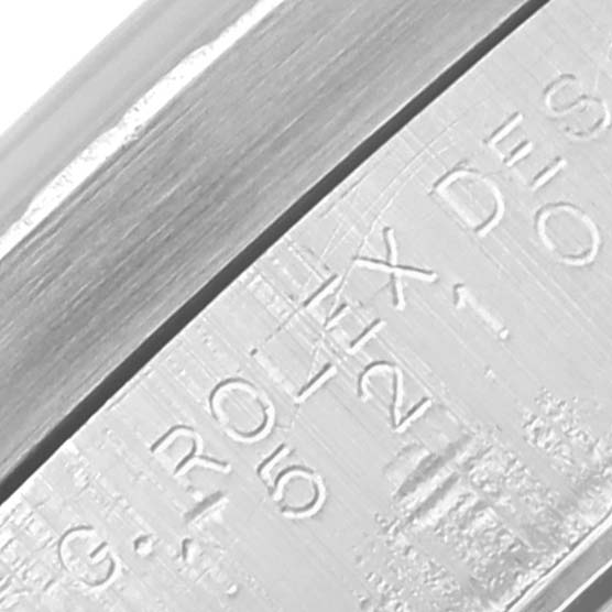 The image shows a close-up of the Rolex Date 15210 Men's Stainless Steel Silver Dial 15210 Men's Stainless Steel Silver Dial model, focusing on its engraved case or clasp.