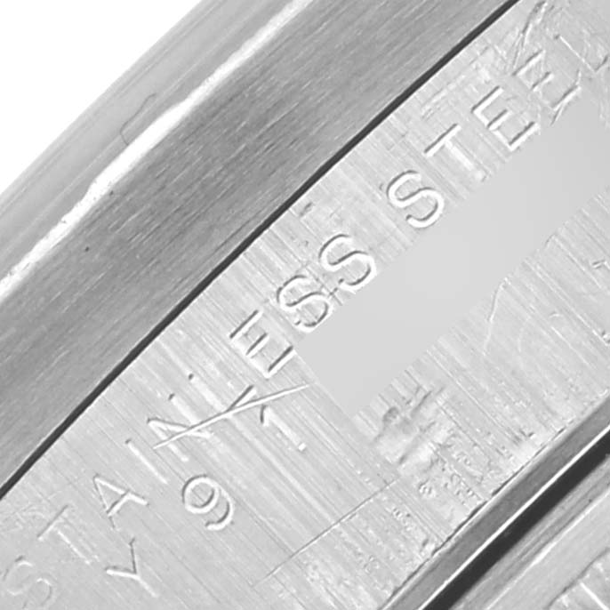 The image shows a close-up of the inner bezel with "STAINLESS STEEL" engraving on a Rolex Date 15210 Men's Stainless Steel Silver Dial 15210 Men's Stainless Steel Silver Dial model.