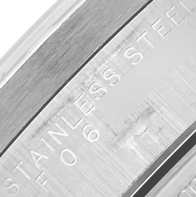The image shows a close-up of the case edge with "STAINLESS STEEL" engraving on the Rolex Date 15210 Men's Stainless Steel White Dial 15210 Men's Stainless Steel White Dial model.