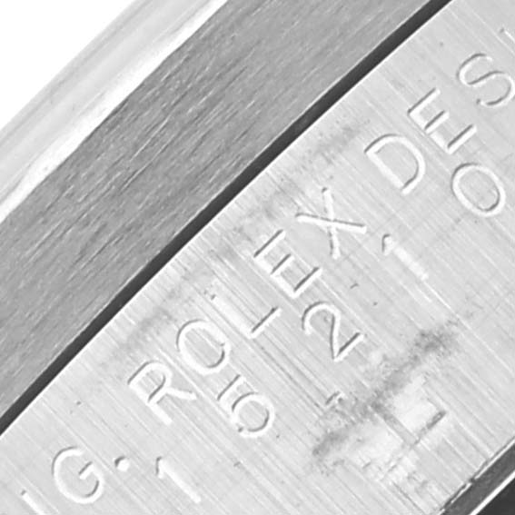 The image shows a close-up of the side of a Rolex Date 15210 Men's Stainless Steel White Dial 15210 Men's Stainless Steel White Dial model, focusing on the engraved details.
