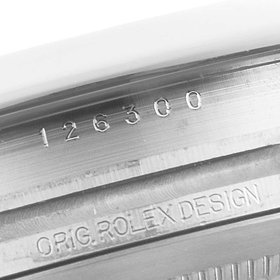 The image shows a close-up of the case and serial number engraving on a Rolex Datejust 41 126300 Men
s Stainless Steel Grey Dial 126300 Men
s Stainless Steel Grey Dial model.