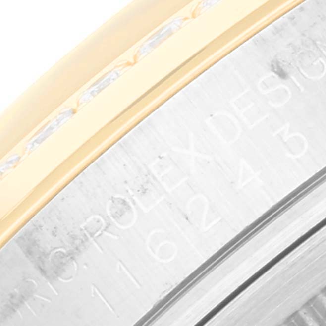 This close-up shot features the side view of the bezel and serial number engraving of a Rolex Datejust 116243 Men's Steel and Gold (two tone) Black Dial 116243 Men's Steel and Gold (two tone) Black Dial watch.