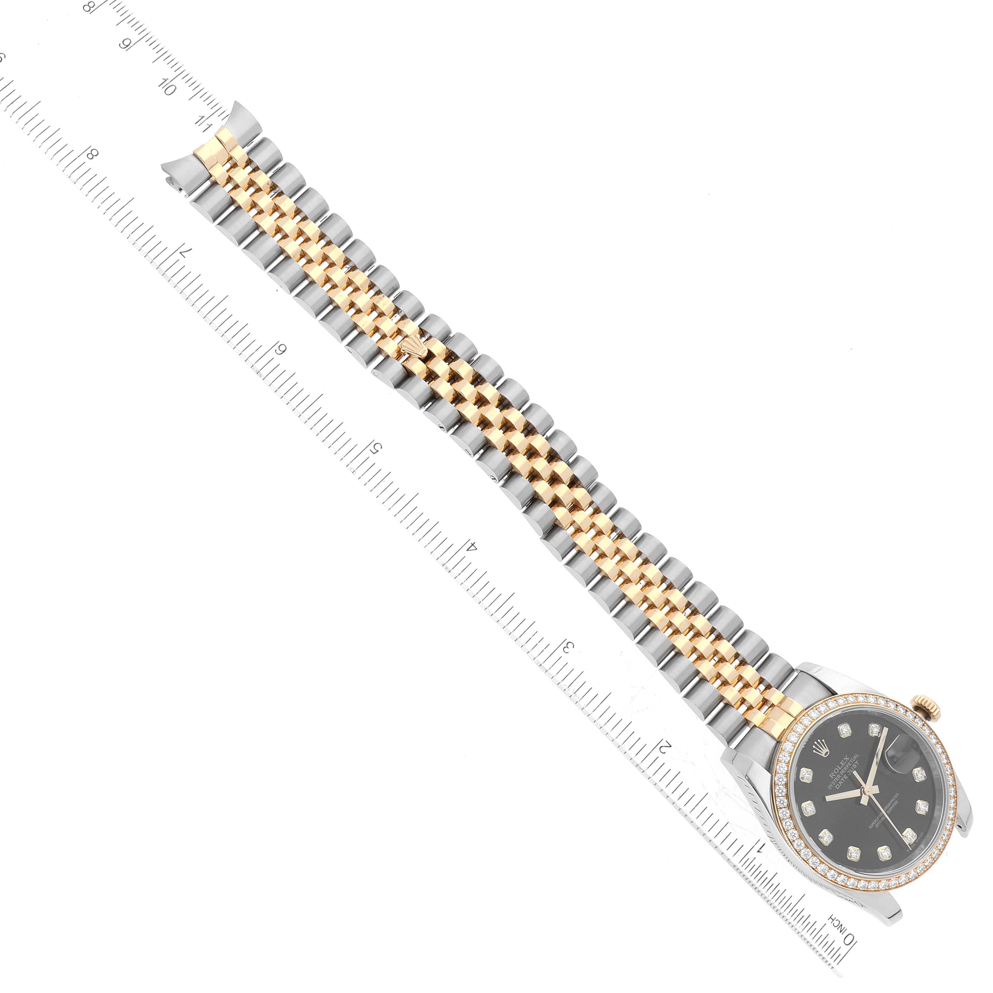 The image shows a top-down view of a Rolex Datejust 116243 Men's Steel and Gold (two tone) Black Dial 116243 Men's Steel and Gold (two tone) Black Dial watch, highlighting the face and two-tone metal bracelet with an adjacent ruler.