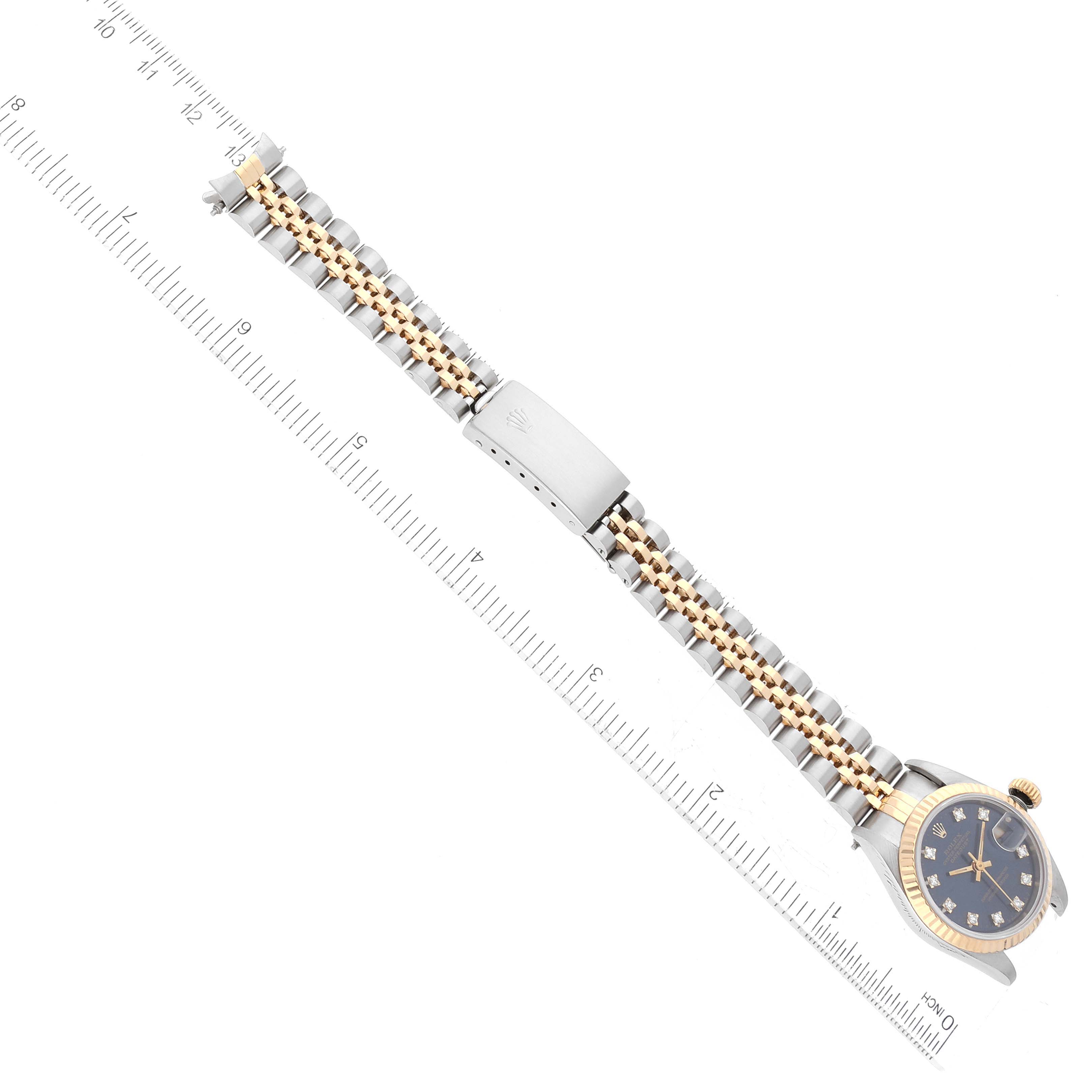 The image shows the entire Rolex Datejust 69173 Women's Steel and Gold (two tone) Blue Dial 69173 Women's Steel and Gold (two tone) Blue Dial watch laid flat, including the dial, bezel, bracelet, and clasp, with a measuring scale.
