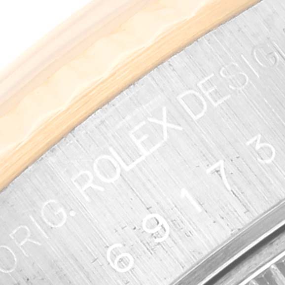 The image shows the edge and engraving of the Datejust model by Rolex at an angled close-up.