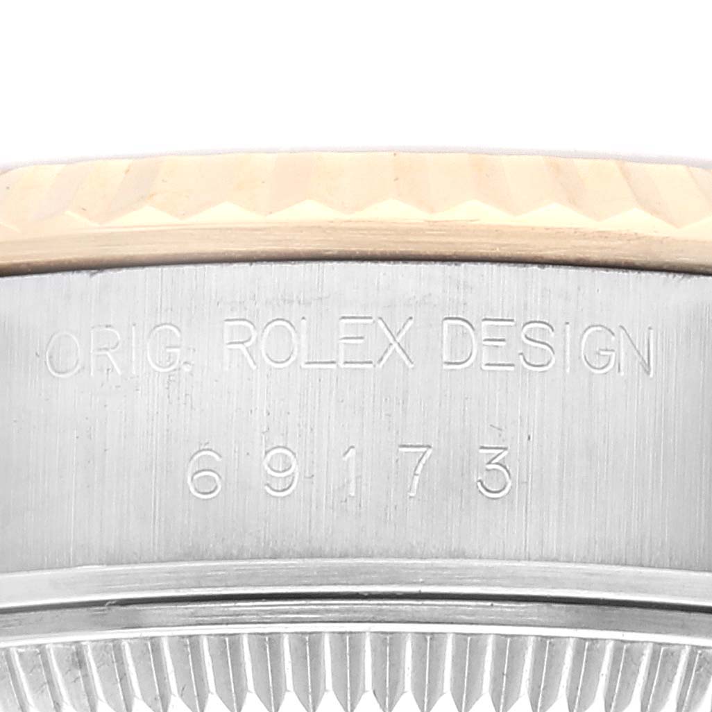 This image shows a close-up of the side of a Rolex Datejust 69173G Women's Steel and Gold (two tone) Champagne Dial 69173G Women's Steel and Gold (two tone) Champagne Dial watch, featuring the model number 69173 and "ORIG. ROLEX DESIGN" engraving.