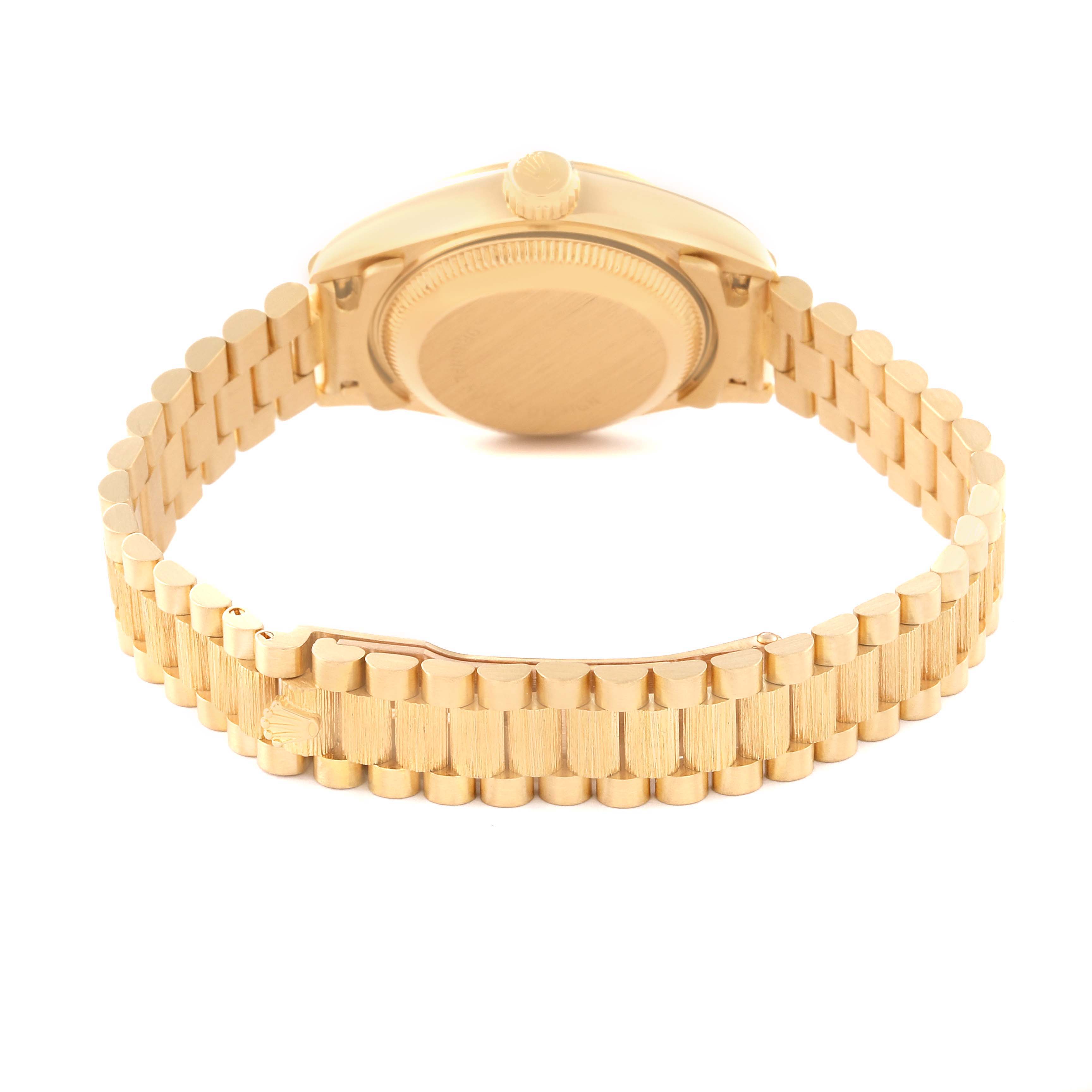 The image shows the back view of a Rolex Datejust 69278 Women's Yellow Gold Black Dial 69278 Women's Yellow Gold Black Dial watch, highlighting its case and gold bracelet.