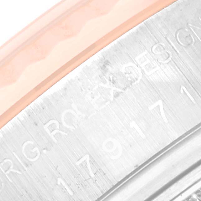 This image shows a close-up angle of the side area of the bezel and engraved details on the Rolex Datejust 179171 Women's Steel and Gold (two tone) Pink Dial 179171 Women's Steel and Gold (two tone) Pink Dial watch.