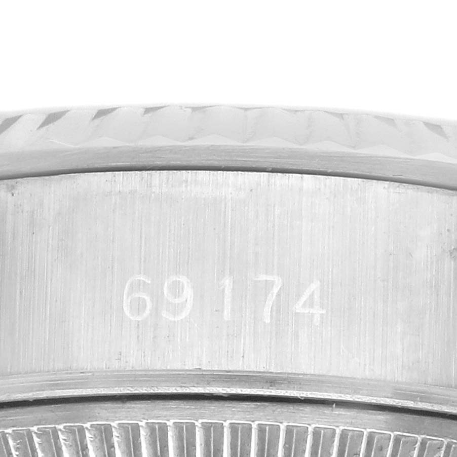The image shows a close-up side view of the Rolex Datejust 69174 Women's Stainless Steel Silver Dial 69174 Women's Stainless Steel Silver Dial model's case, focusing on the model number engraving.