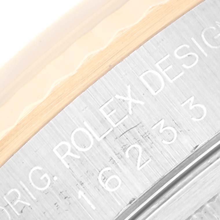 Close-up of the side engraving on a Rolex Datejust 16233 Men's Steel and Gold (two tone) Beige Dial 16233 Men's Steel and Gold (two tone) Beige Dial showing the brand name and model number.