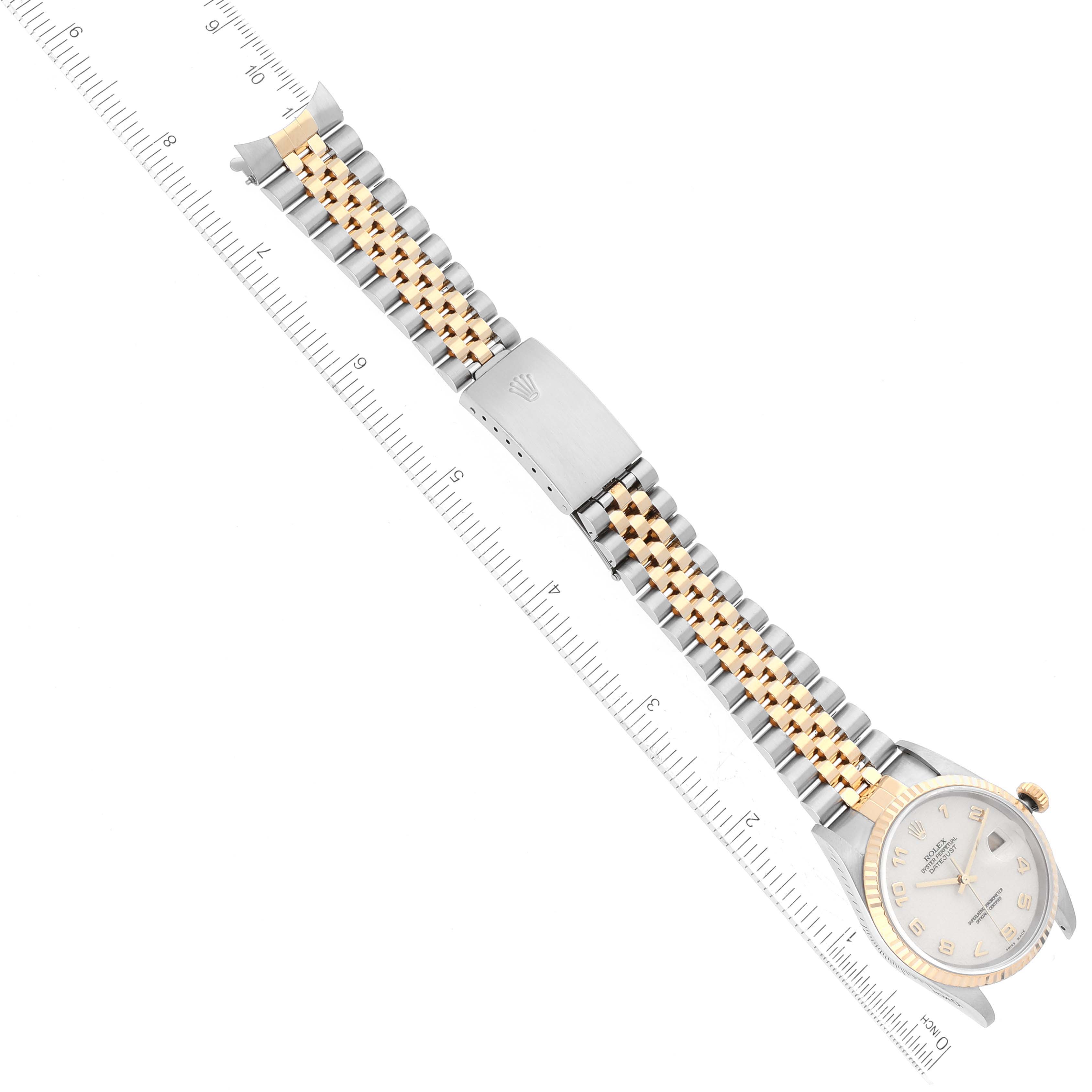 The image shows a Rolex Datejust 16233 Men's Steel and Gold (two tone) Beige Dial 16233 Men's Steel and Gold (two tone) Beige Dial watch laid flat with an integrated ruler for scale, featuring its band and part of the dial.