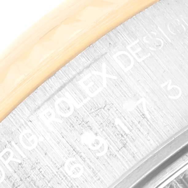 The image shows a close-up of the engraved edge of the dial of a Rolex Datejust 69173 Women's Steel and Gold (two tone) White Dial 69173 Women's Steel and Gold (two tone) White Dial watch.