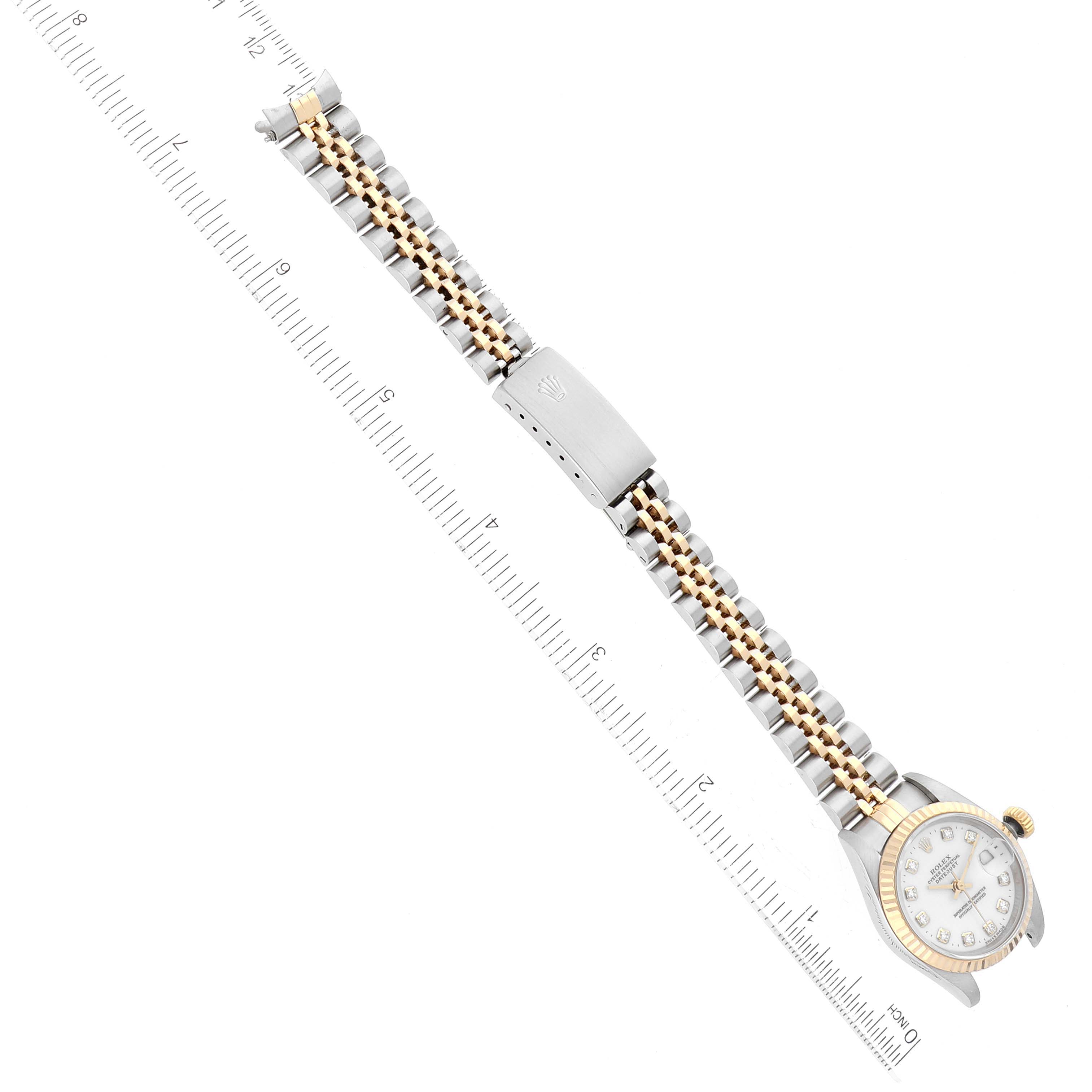 The image shows a Rolex Datejust 69173 Women's Steel and Gold (two tone) White Dial 69173 Women's Steel and Gold (two tone) White Dial watch laid flat, showcasing the full bracelet and clasp next to a ruler for scale.