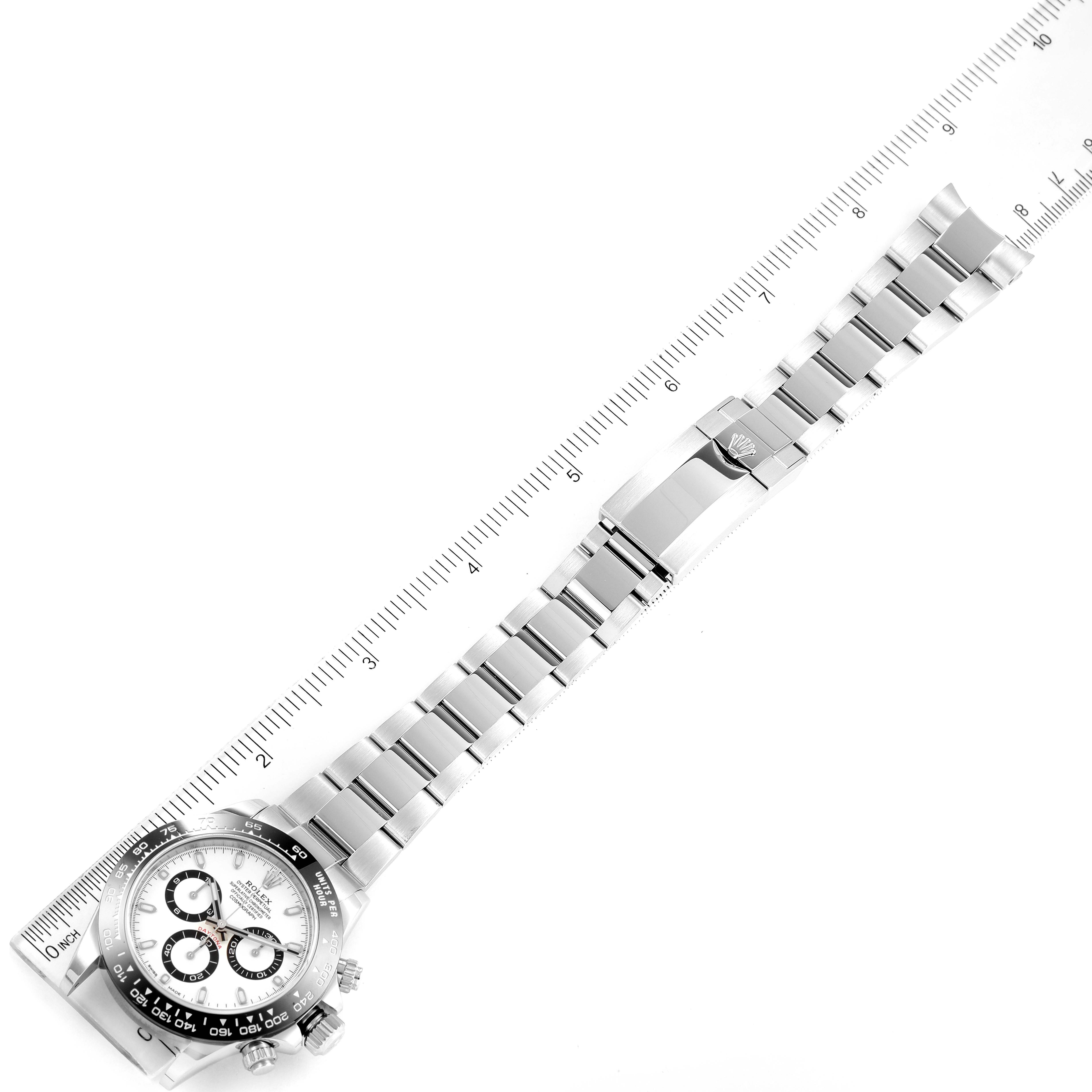 This image shows a Rolex Daytona 116500 Men's Stainless Steel White Dial 116500 Men's Stainless Steel White Dial watch laid flat with a ruler aligning the band for measurement.
