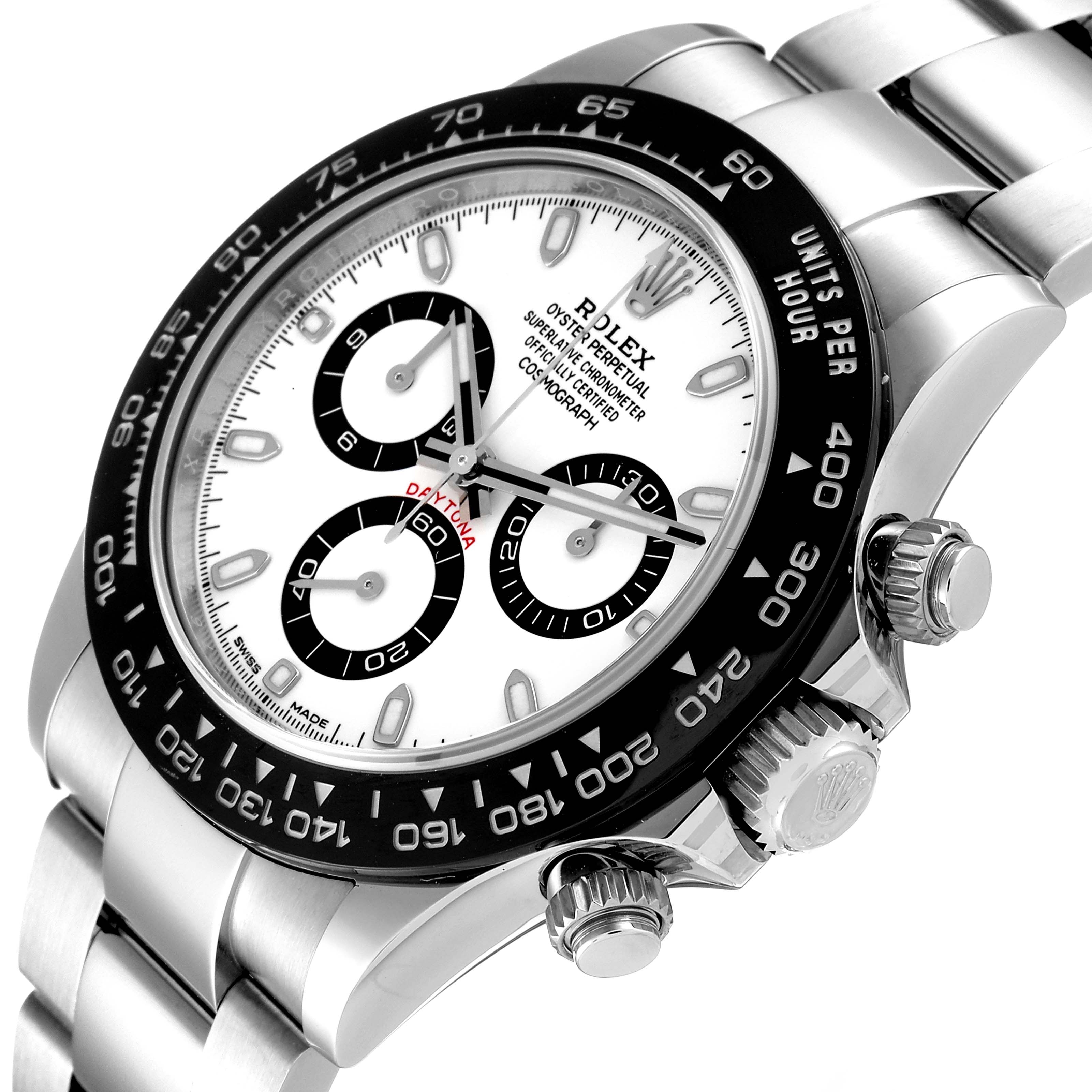 This image shows a Rolex Daytona 116500 Men's Stainless Steel White Dial 116500 Men's Stainless Steel White Dial watch tilted at an angle focusing on the dial, bezel, crown, and part of the bracelet.