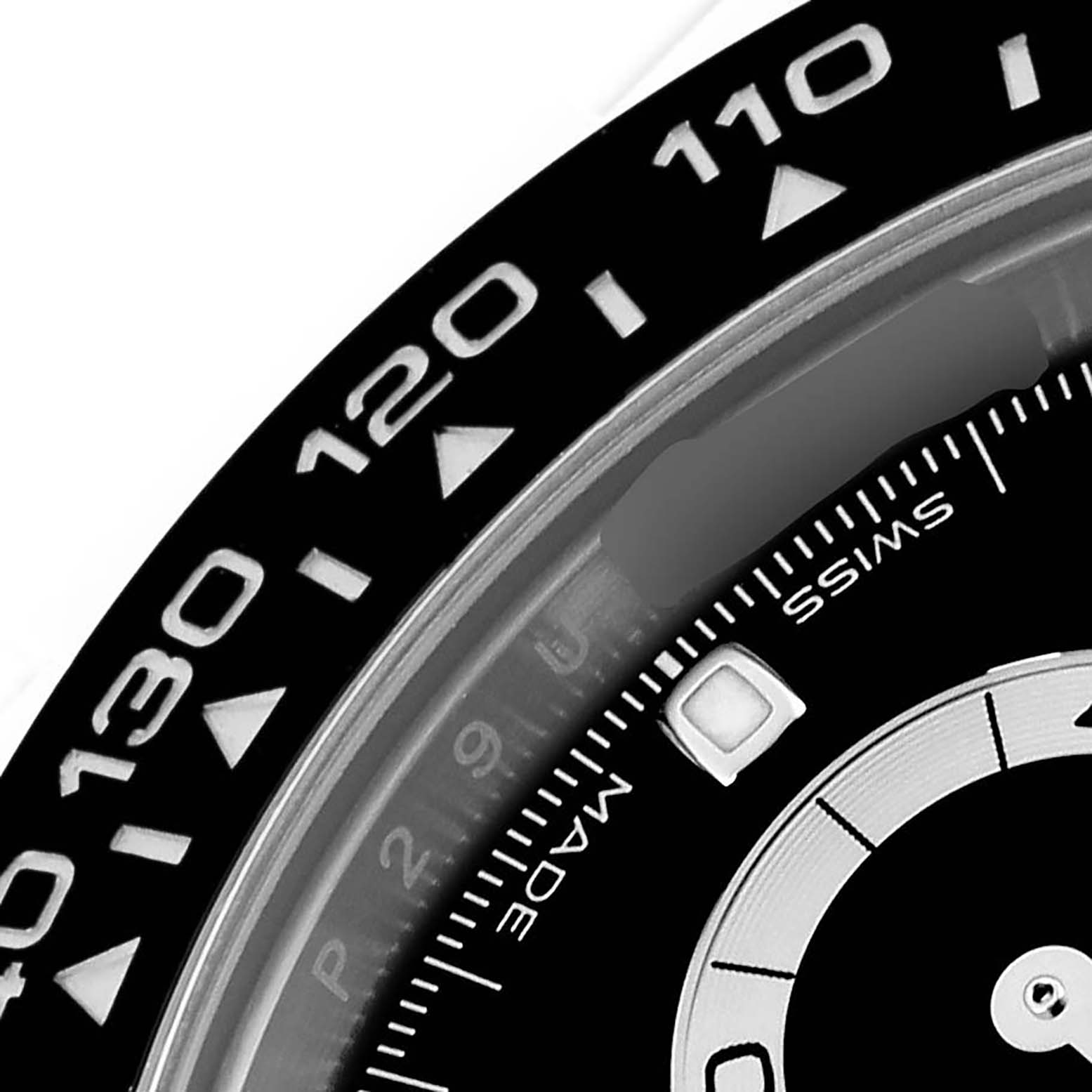 The image shows a close-up of the bezel and part of the dial of a Rolex Daytona 116500LN Men's Stainless Steel Black Dial 116500LN Men's Stainless Steel Black Dial watch, featuring tachymetric scale markings.