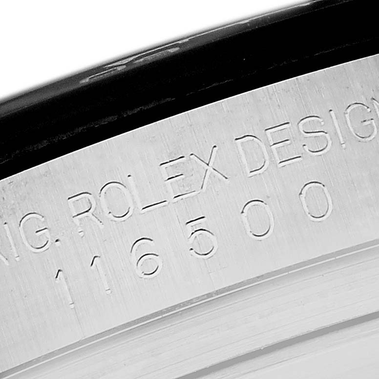 The image shows an angled close-up of the engraved inner bezel of the Rolex Daytona 116500LN Men's Stainless Steel Black Dial 116500LN Men's Stainless Steel Black Dial watch.