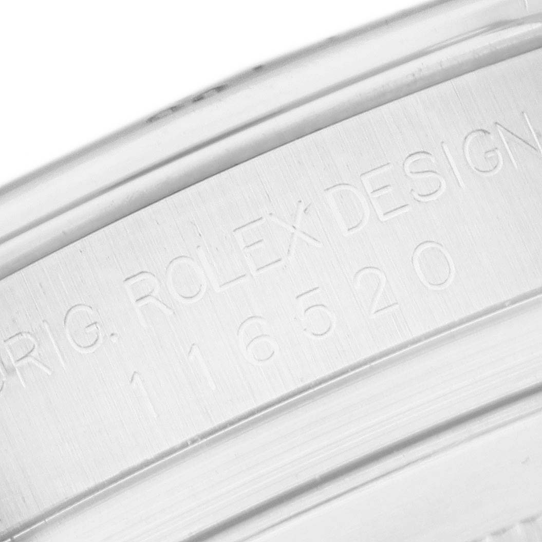This image shows a close-up of the case side of a Rolex Daytona 116520 Men
s Stainless Steel White Dial 116520 Men
s Stainless Steel White Dial watch with engraving.