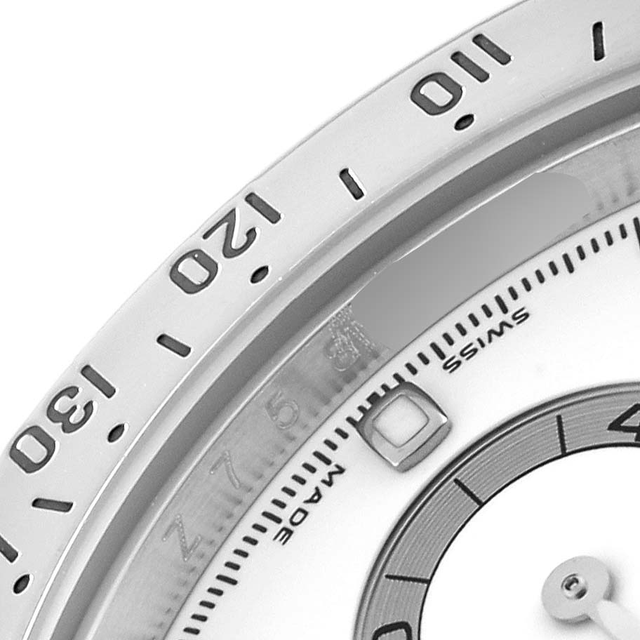 This close-up angle shows part of the bezel, dial, and some numerical markers of the Rolex Daytona 116520 Men
s Stainless Steel White Dial 116520 Men
s Stainless Steel White Dial watch.