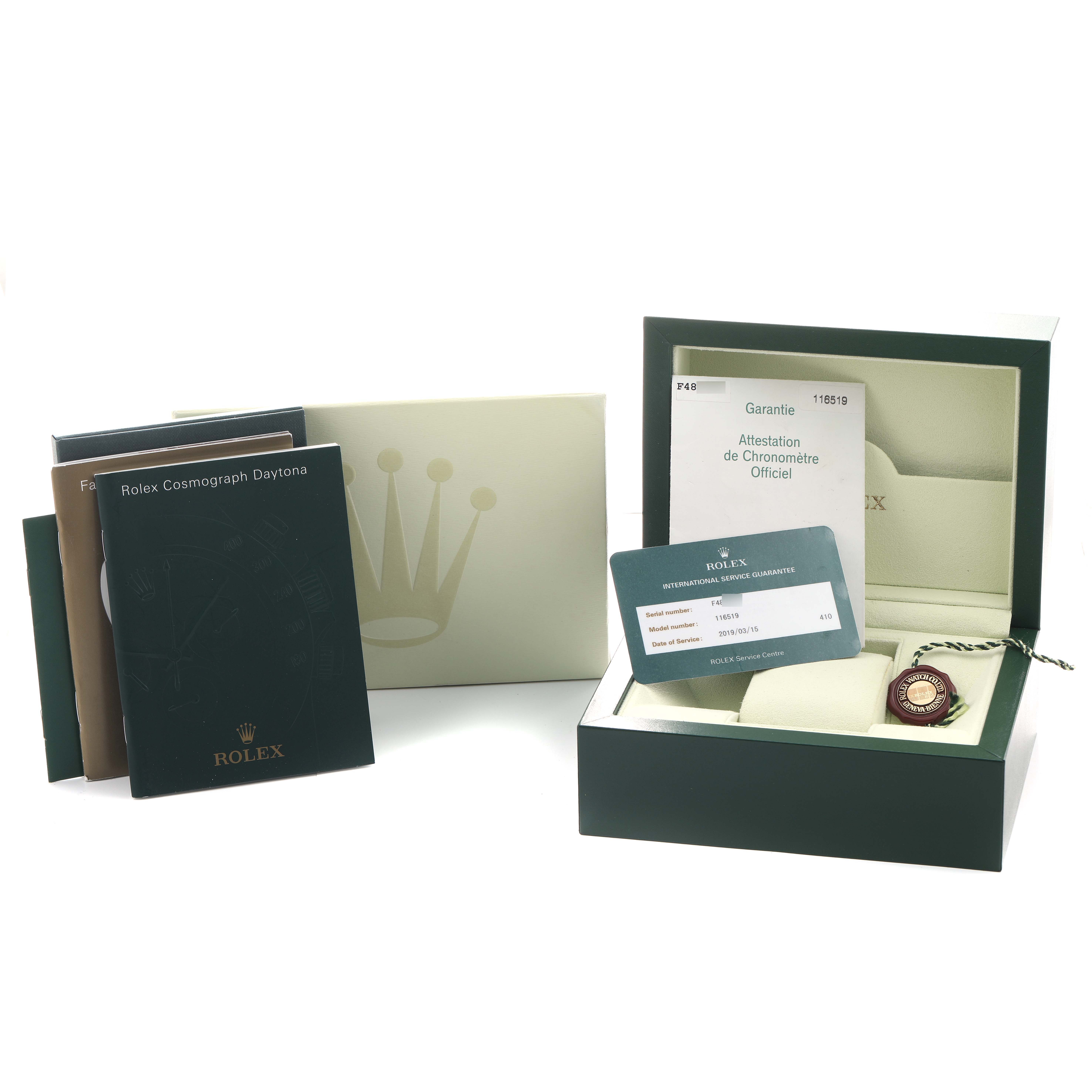 The image shows the packaging and accessories for a Rolex Daytona 116519 Men's White Gold Silver Dial watch, including manuals, warranty cards, and a box, seen from above.