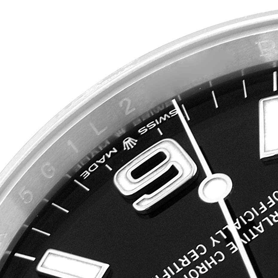This image shows a close-up of the dial and bezel of a Rolex Explorer 124270 Men
s Stainless Steel Black Dial 124270 Men
s Stainless Steel Black Dial model, featuring the number 9 and "Swiss Made" text.