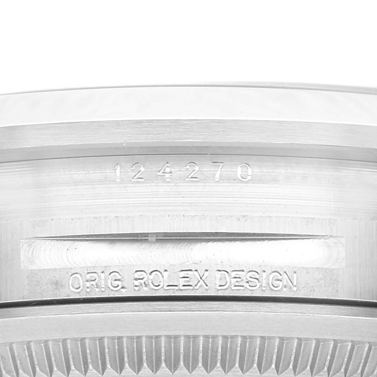 This image shows a close-up view of the case side of a Rolex Explorer 124270 Men
s Stainless Steel Black Dial 124270 Men
s Stainless Steel Black Dial watch, featuring the model number and "ORIG ROLEX DESIGN" inscription.