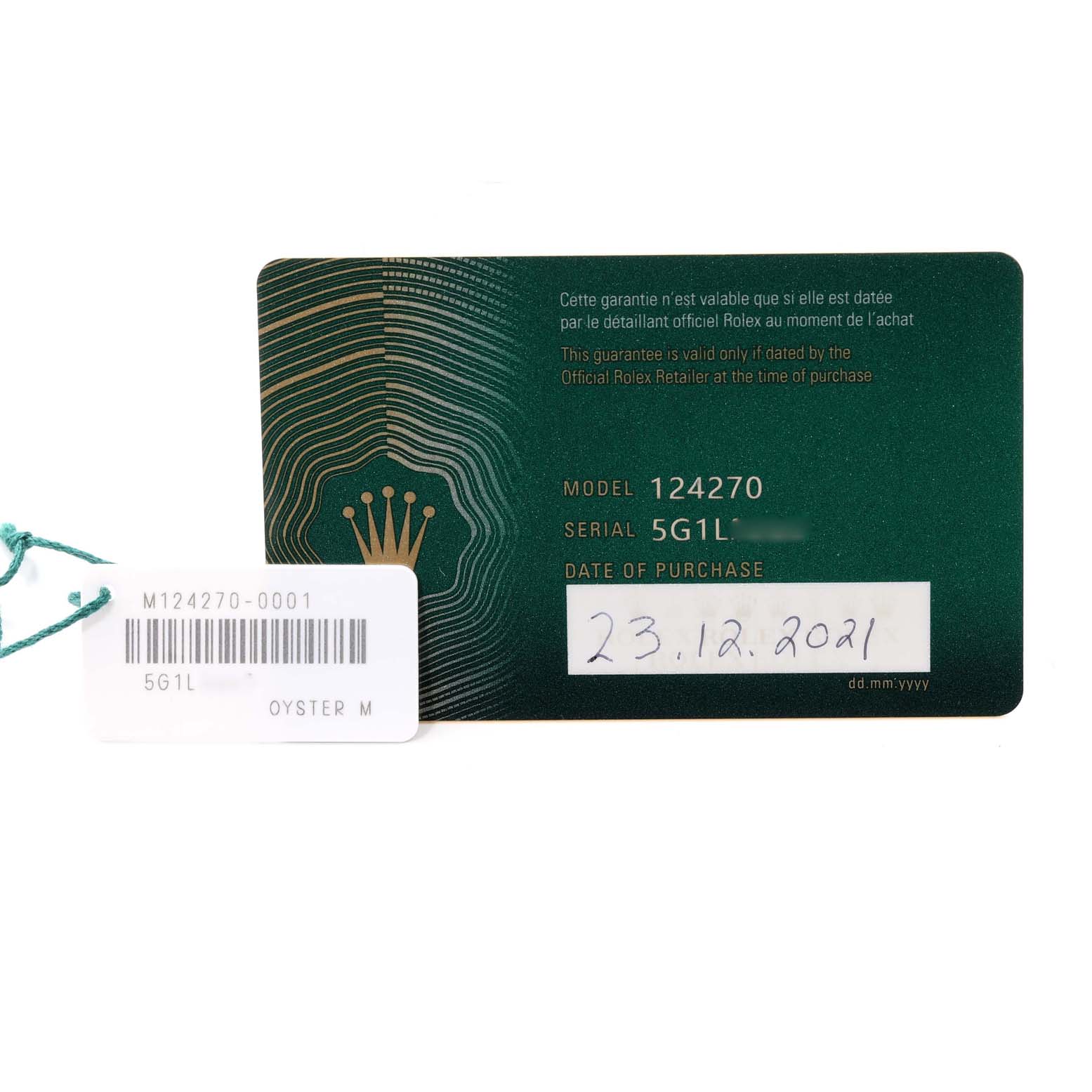 The image shows the warranty card and a tag for the Rolex Explorer 124270 Men
s Stainless Steel Black Dial 124270 Men
s Stainless Steel Black Dial model 124270.