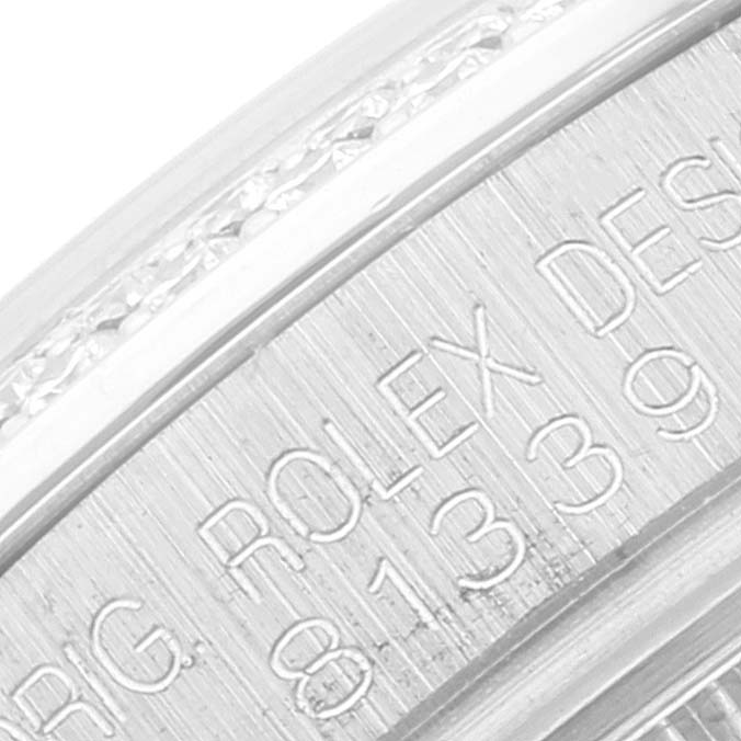 The image shows a close-up of the engravings on the bezel of a Rolex Pearlmaster 81339 Women
s White Gold Silver Dial 81339 Women
s White Gold Silver Dial watch.