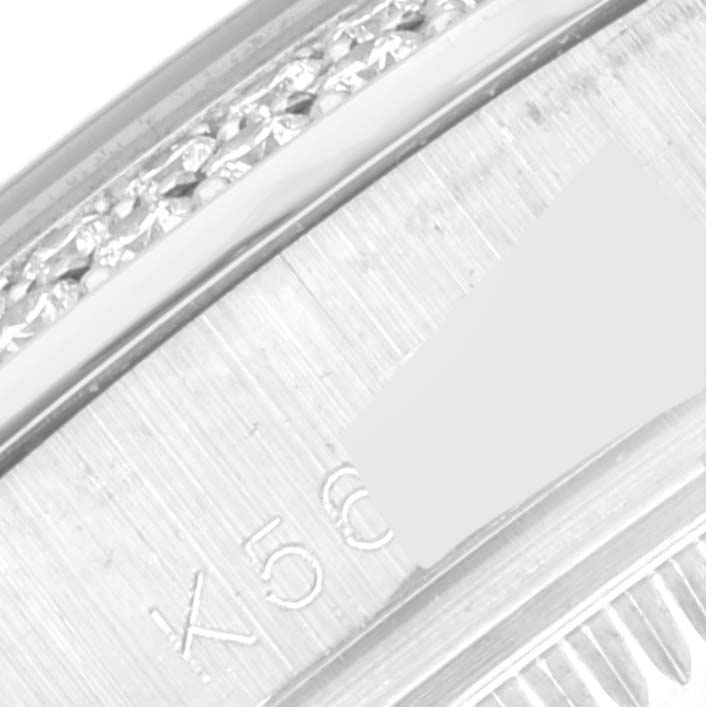 This image shows a close-up of the side view of the Rolex Pearlmaster 81339 Women
s White Gold Silver Dial 81339 Women
s White Gold Silver Dial watch bezel and part of the casing with engraved numbers.