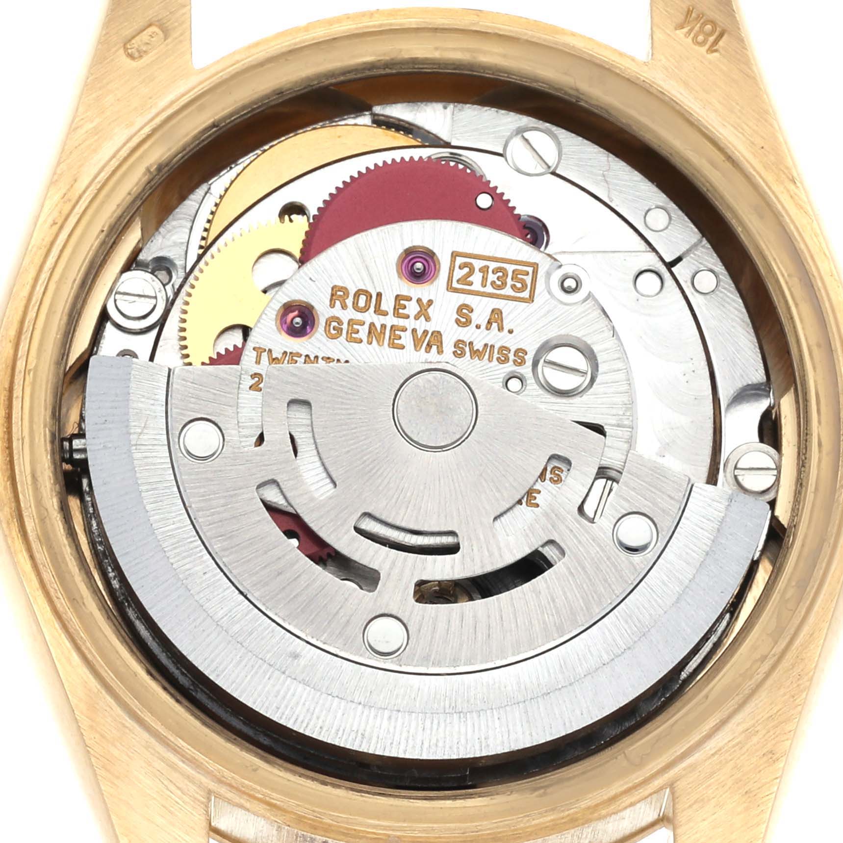 The image shows a close-up of the Rolex President 69178 Women's Yellow Gold Black Dial 69178 Women's Yellow Gold Black Dial model's movement from the back, highlighting gears and engravings.