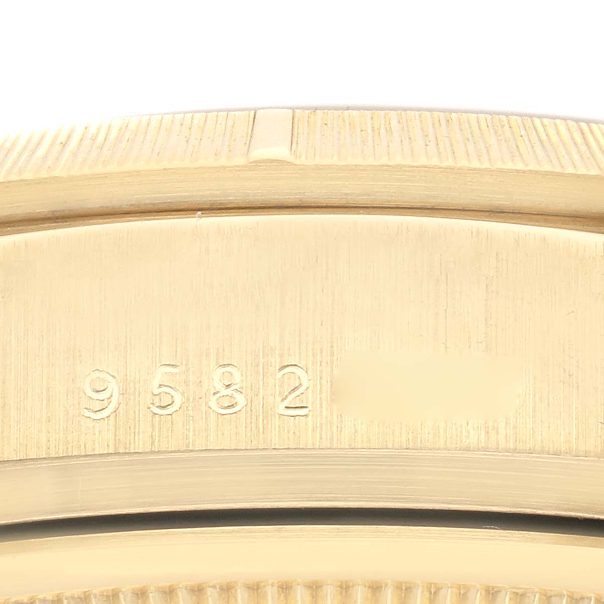 This close-up image shows the engraved serial number on the case of a Rolex President 18078 Men
s Yellow Gold Champagne Dial 18078 Men
s Yellow Gold Champagne Dial model watch.