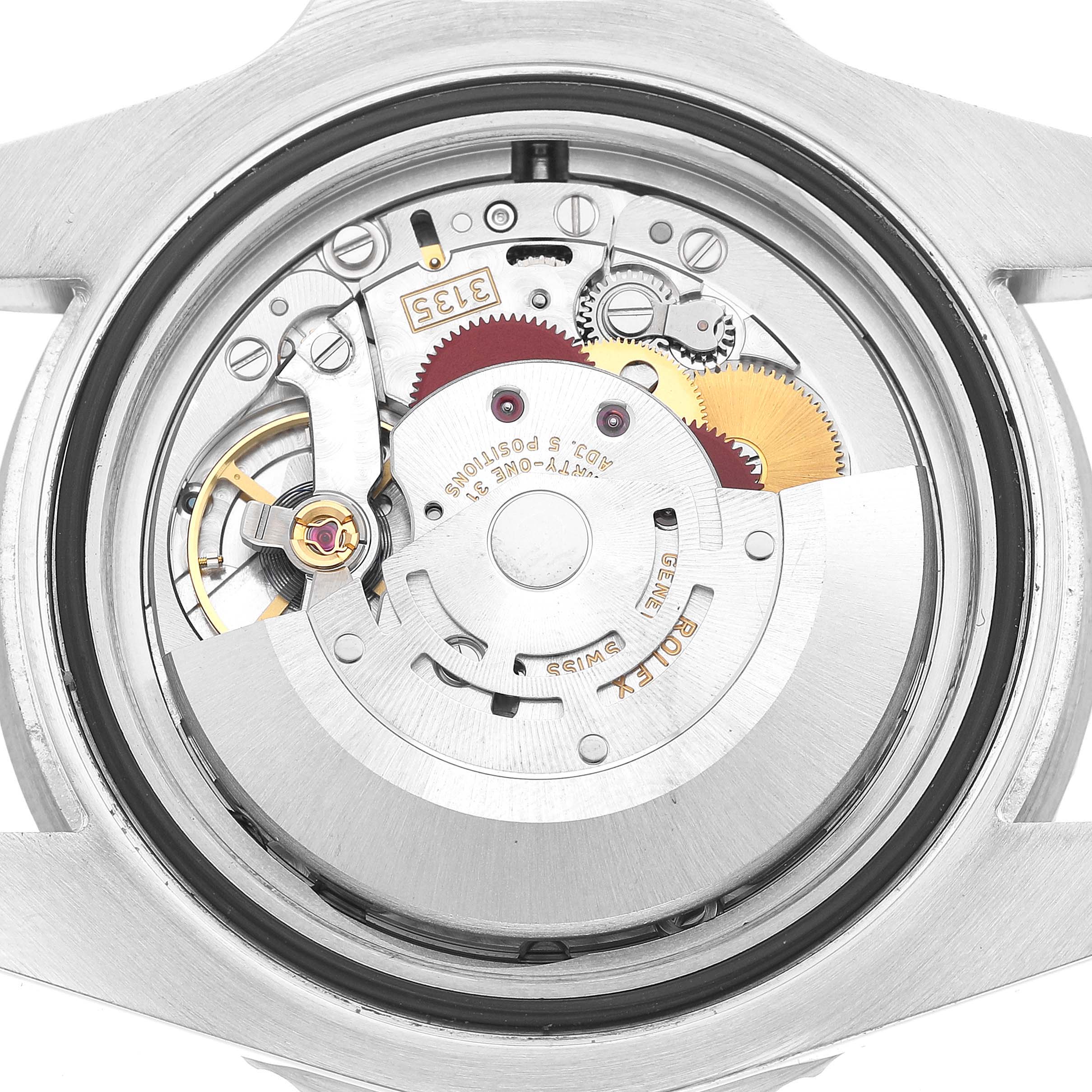 The image shows a Rolex Submariner 116610LV Men's Stainless Steel Green Dial's movement from the back, highlighting gears, rotors, and engravings.