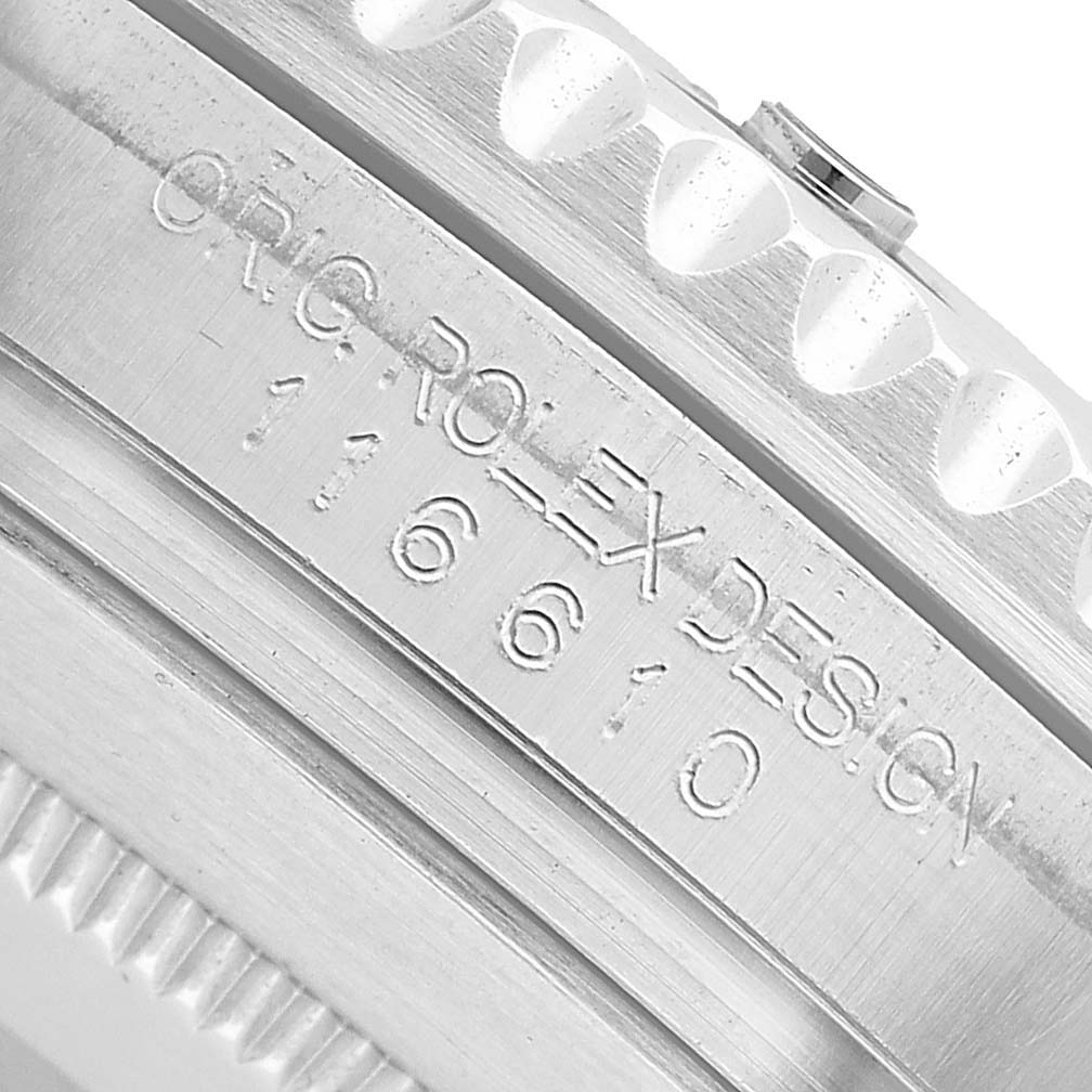 The image shows a close-up of the Rolex Submariner 116610LV Men's Stainless Steel Green Dial's engraved case side, highlighting the crown and bezel edge.