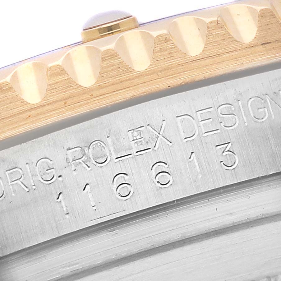 The image shows a close-up of the bezel and case side of a Rolex Submariner 116613LB Men's Steel and Gold (two tone) Blue Dial 116613LB Men's Steel and Gold (two tone) Blue Dial, including the serial engraving.