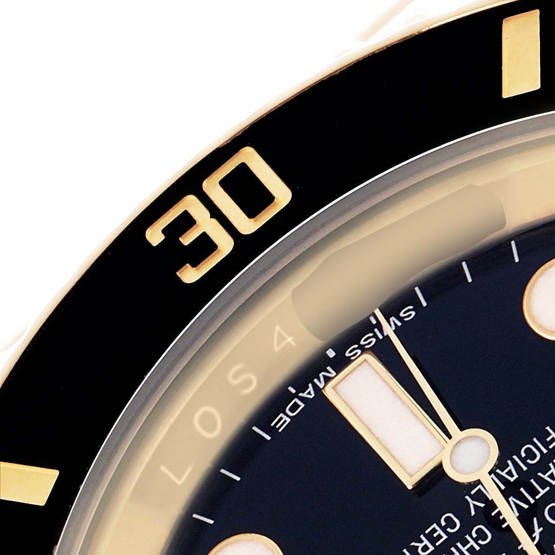 The image shows a close-up of the dial and bezel of a Rolex Submariner 116618LN Men's Yellow Gold Black Dial, focusing on the minute indices and part of the hands.