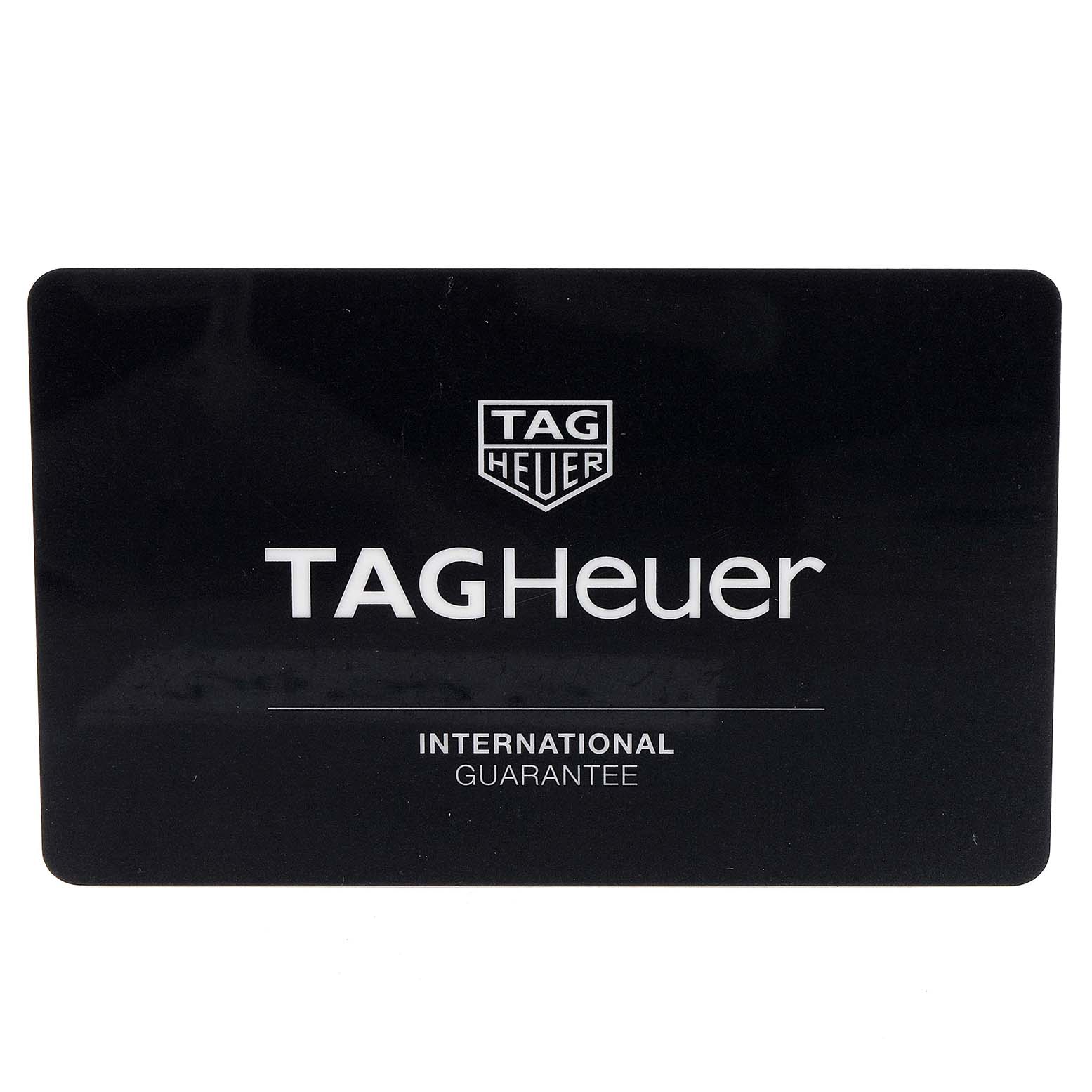The image shows a black TAG Heuer International Guarantee card for the Carrera model.