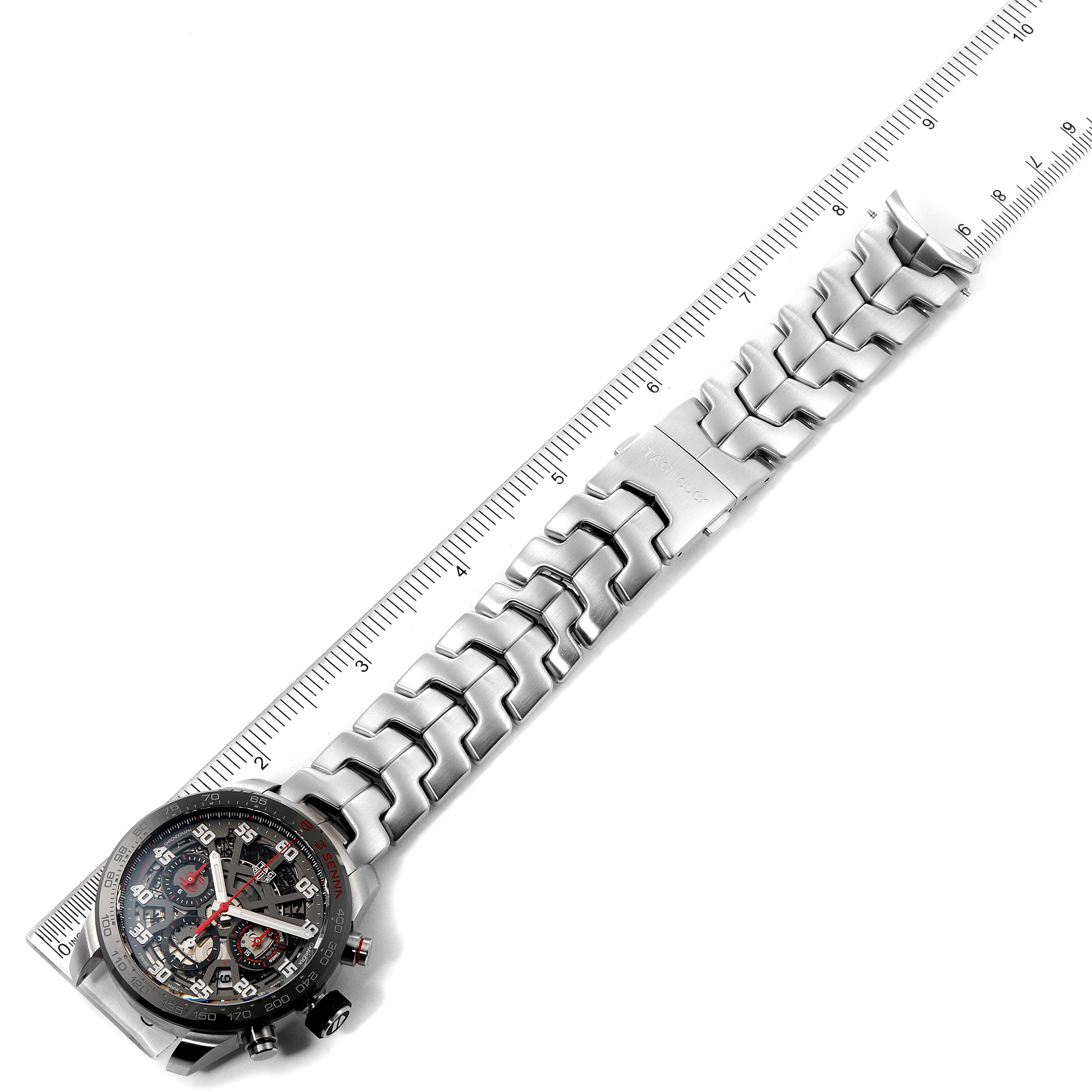 The image shows a Tag Heuer Carrera CBG2013.BA0657 Men's Stainless Steel Transparent Dial CBG2013.BA0657 Men's Stainless Steel Transparent Dial watch laid flat with a ruler measuring the length of its metal bracelet.
