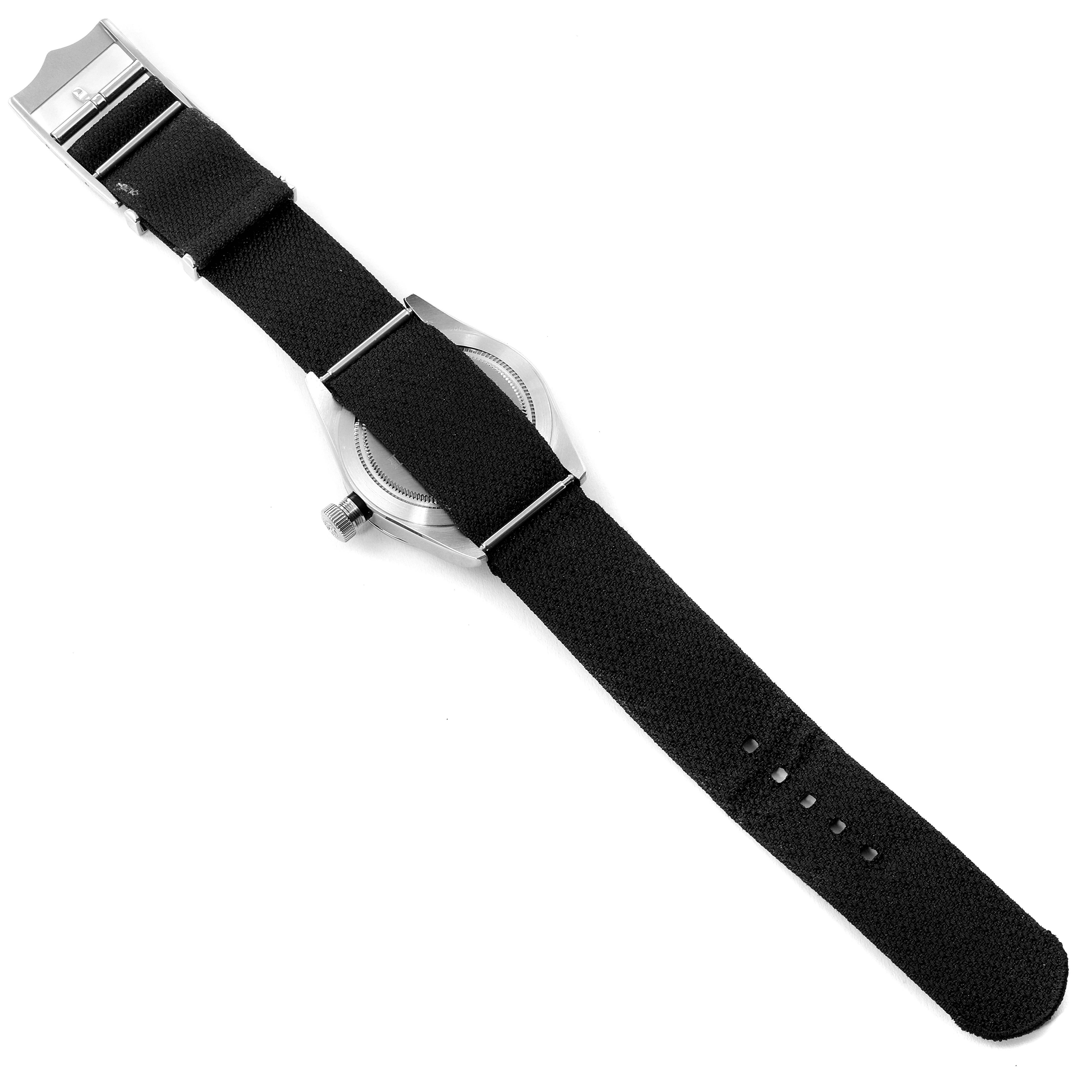 The Heritage Black Bay model by Tudor is shown from the back, displaying the case back and black fabric strap.
