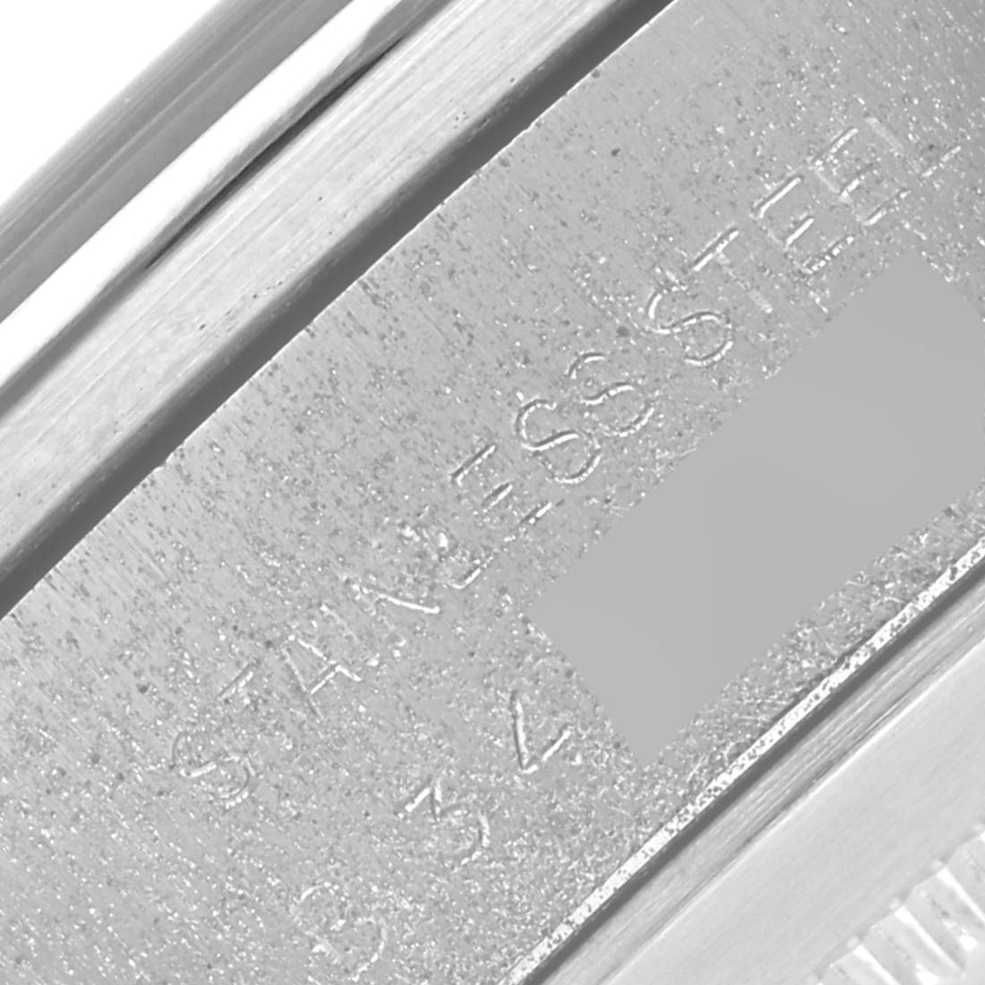 The image shows a close-up of the engraved side of a Tudor Prince 79180 Men's Stainless Steel Black Dial 79180 Men's Stainless Steel Black Dial model watch, highlighting the stainless steel material.